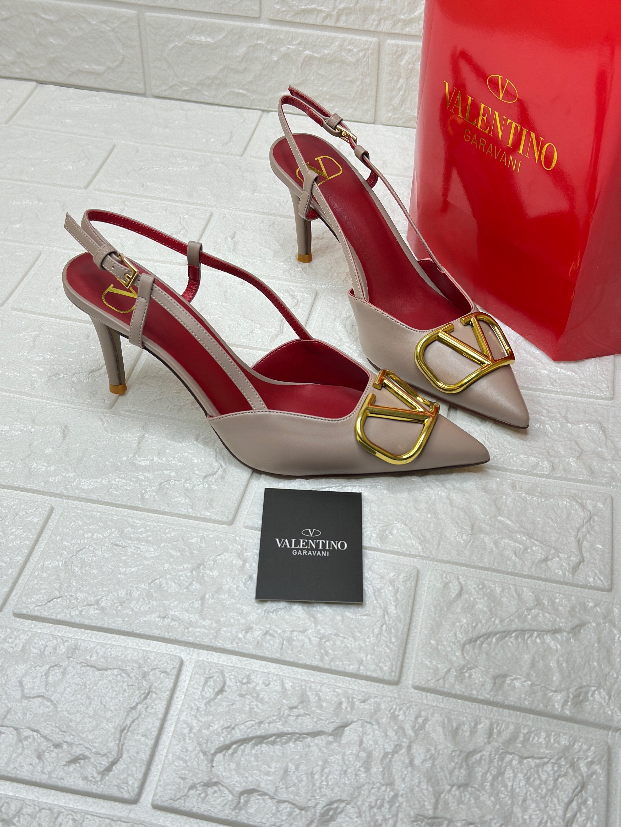 Valentino Garavani VLogo Signature calfskin slingback pumps in a nude or "poudre" color. image 1