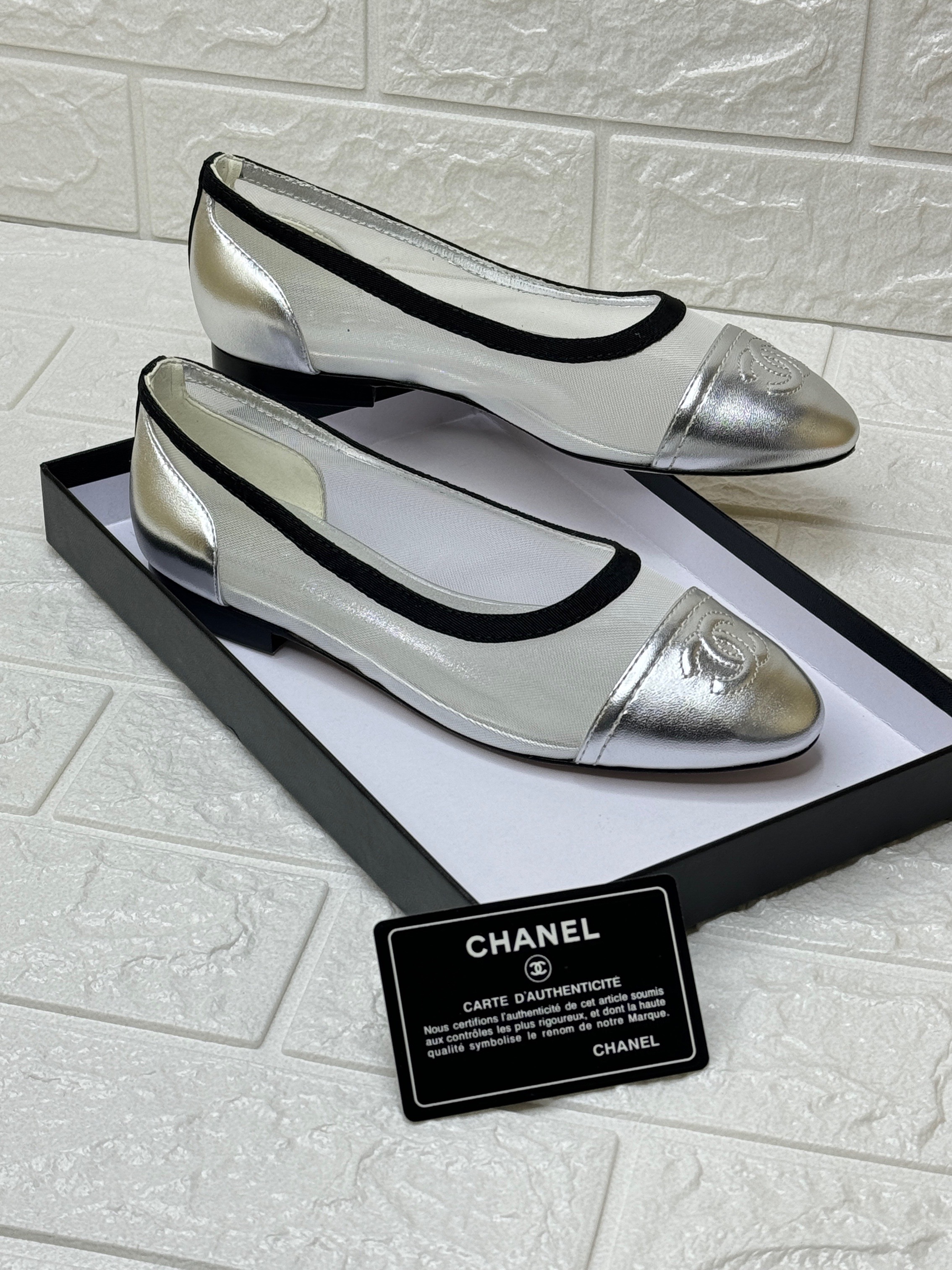 Chanel ballet flats with a silver cap toe and a sheer, possibly canvas or mesh, upper. image 1