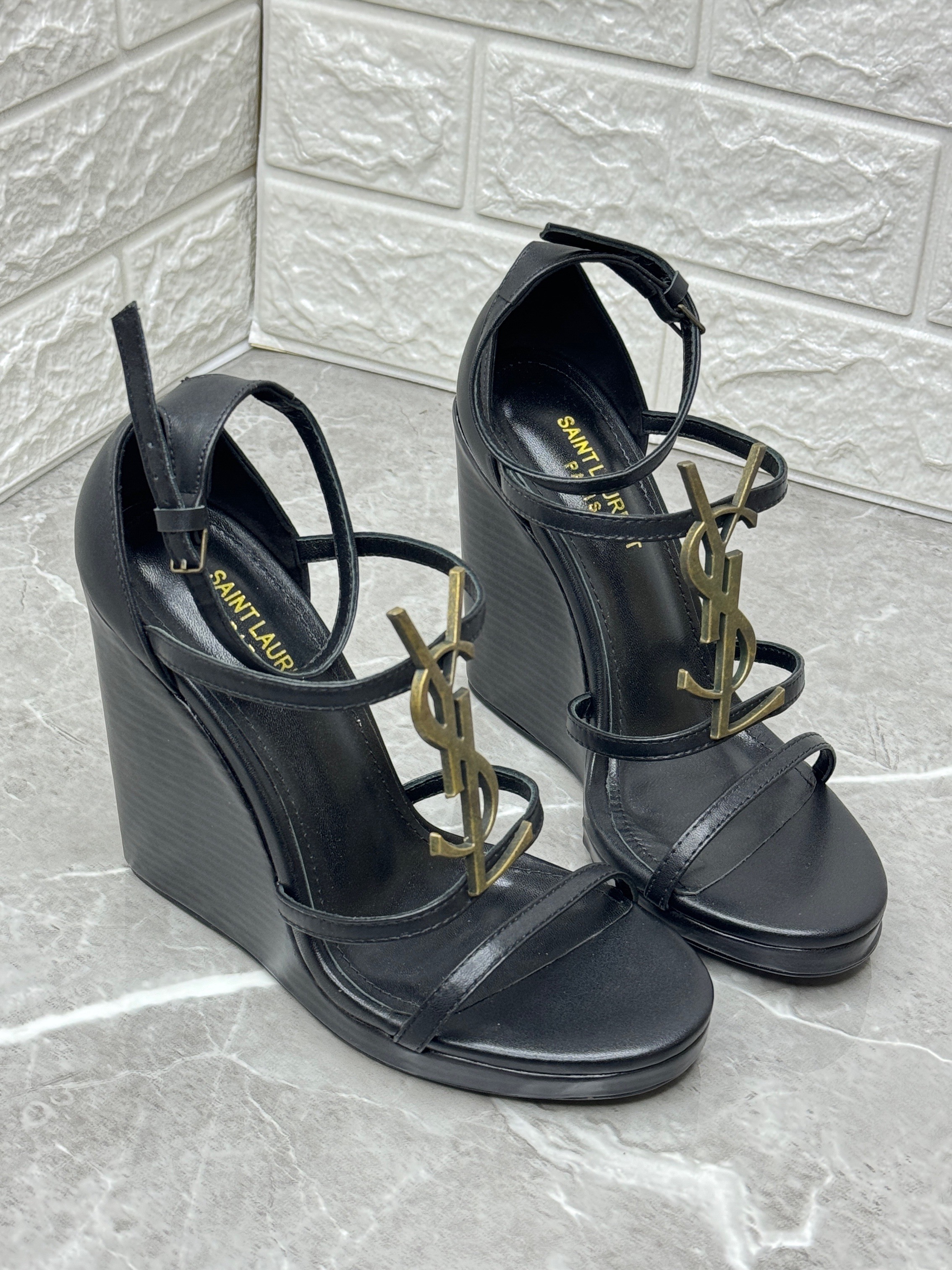 Saint Laurent Cassandra wedges in black smooth leather with a gold-tone YSL monogram. image 1