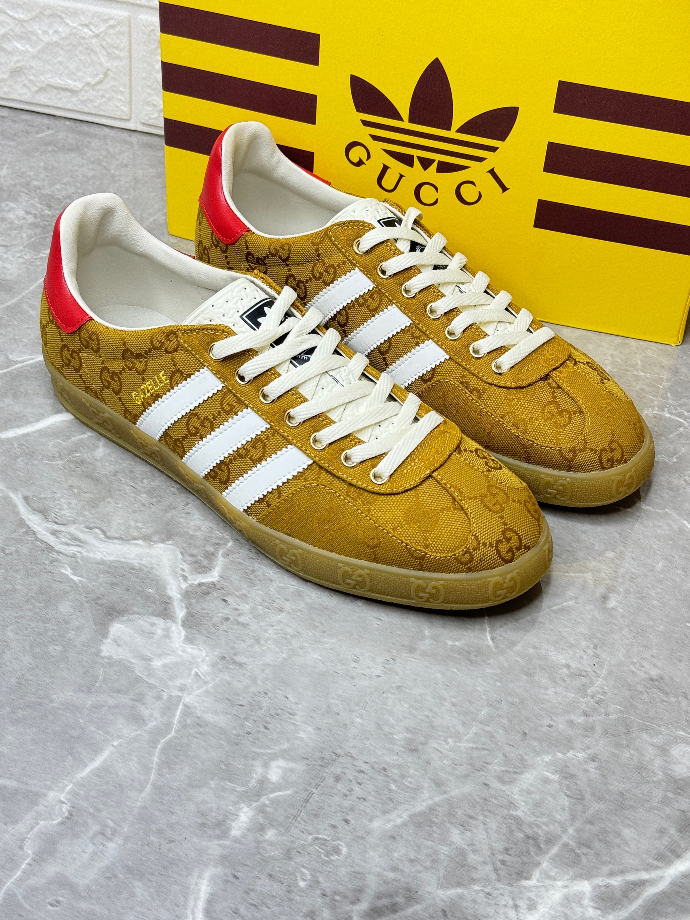 Adidas x Gucci Gazelle low-top sneaker in the beige GG monogram canvas with white stripes and a red heel tab. image 1