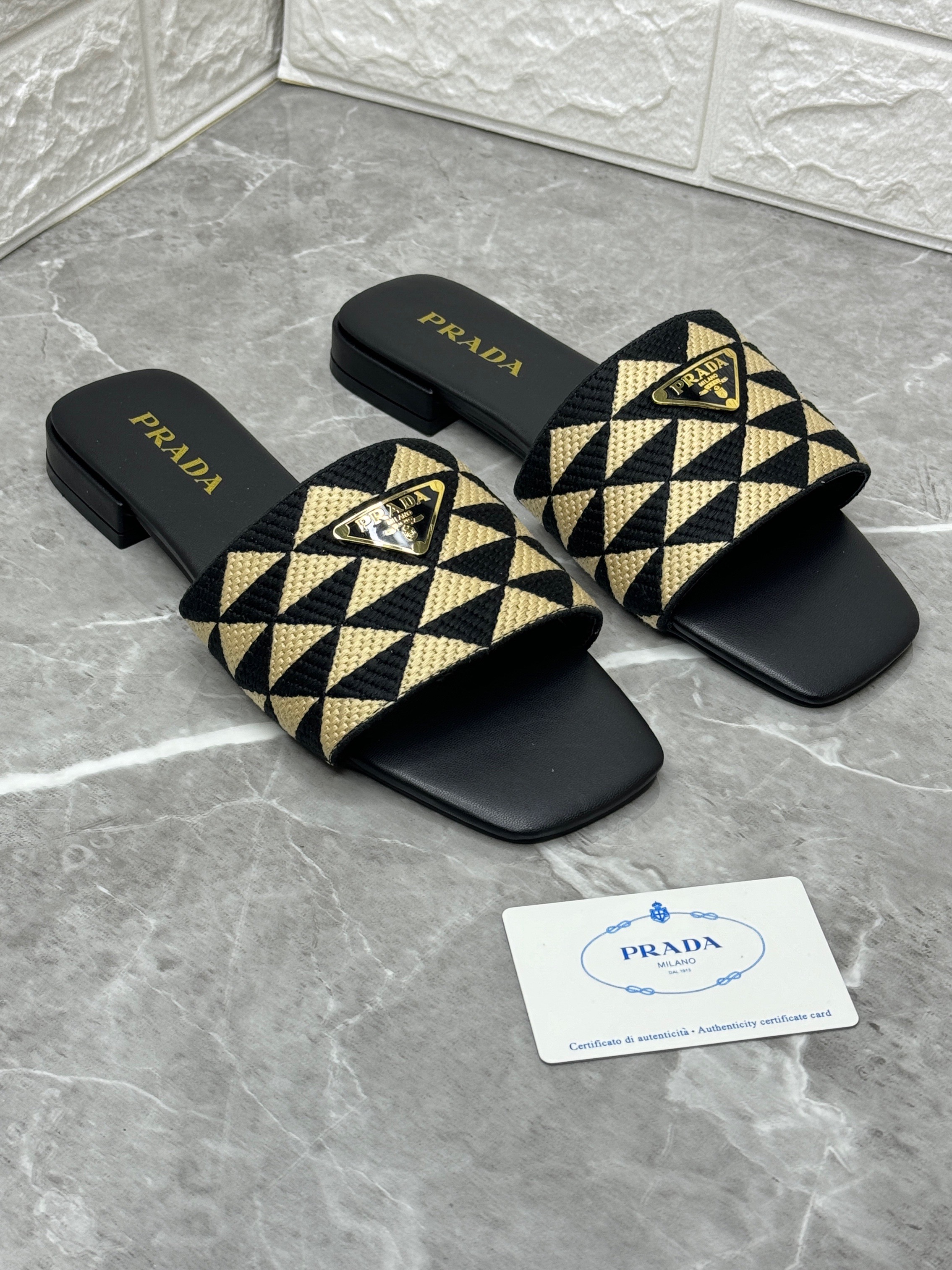 Prada Triangle Jacquard Slide Sandals in black with a geometric pattern and the signature enameled triangle logo plaque. image 1