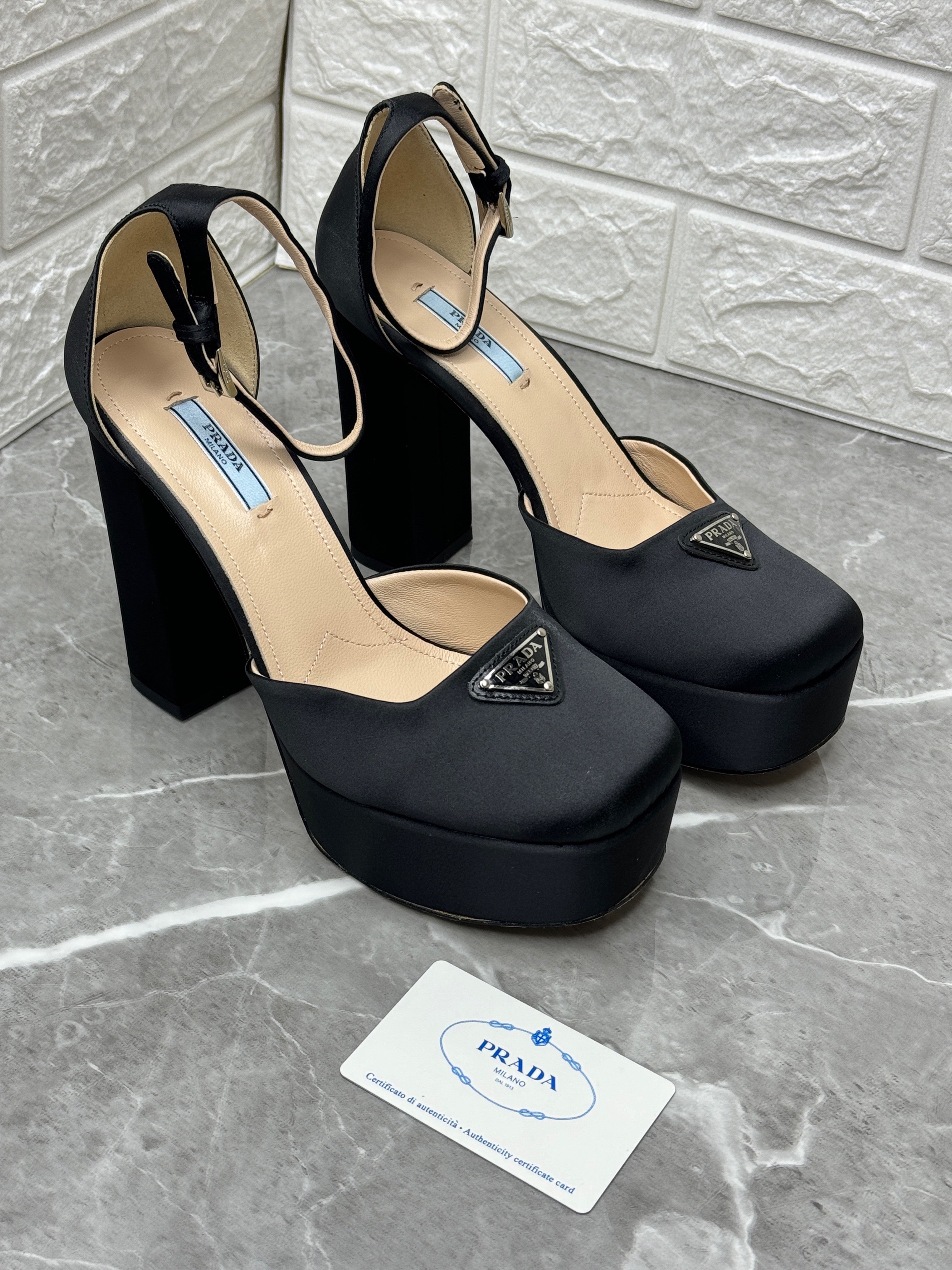 Prada satin platform pumps with an ankle strap and the iconic triangle logo. image 1