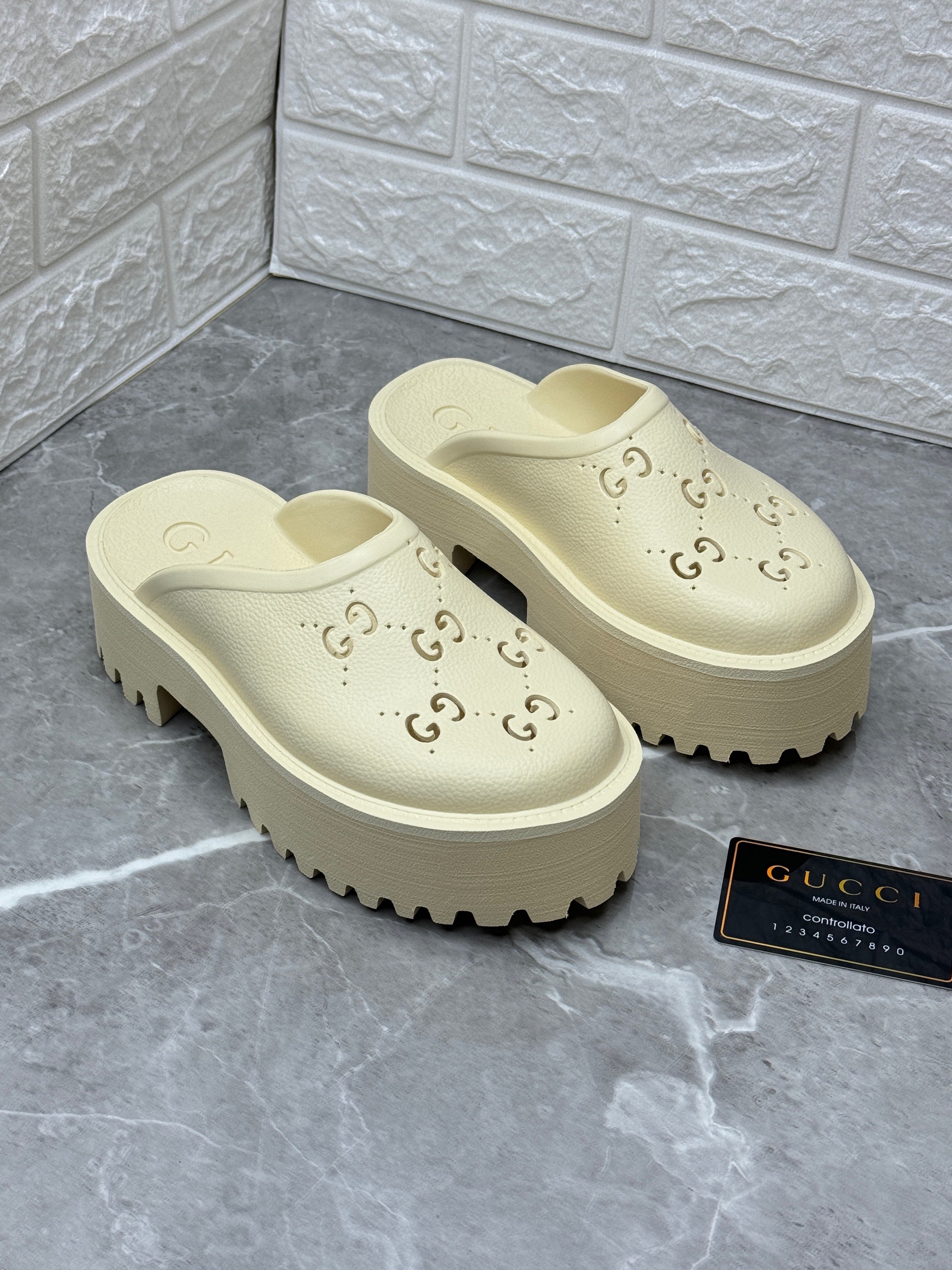Gucci Platform Perforated G Rubber Sandals in white. image 1