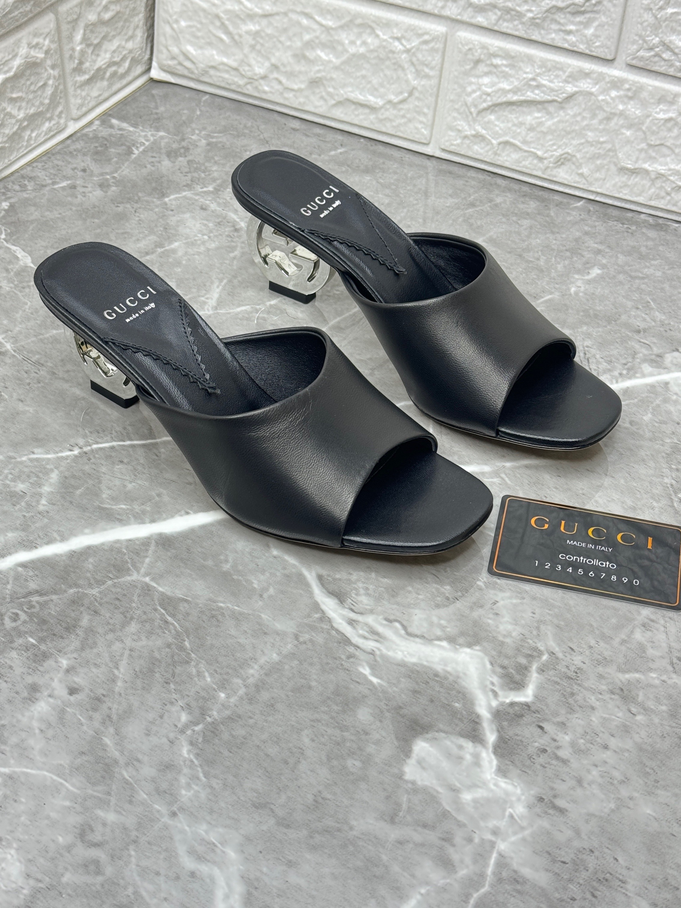 Gucci Interlocking G leather mules in black with a silver-plated interlocking G heel. image 1