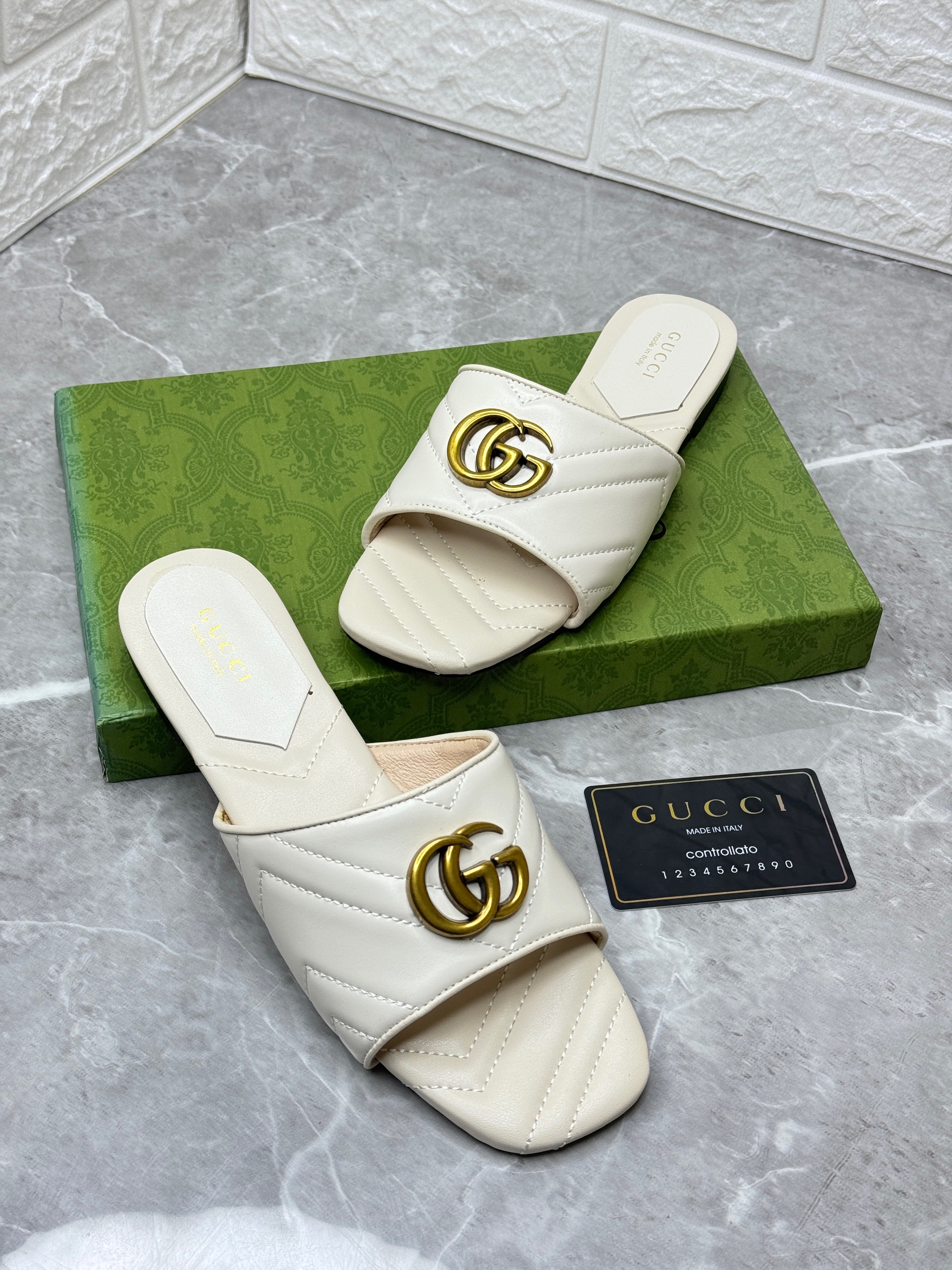 Gucci Double G slide sandals in white chevron matelass? leather with aged gold-toned hardware. image 1