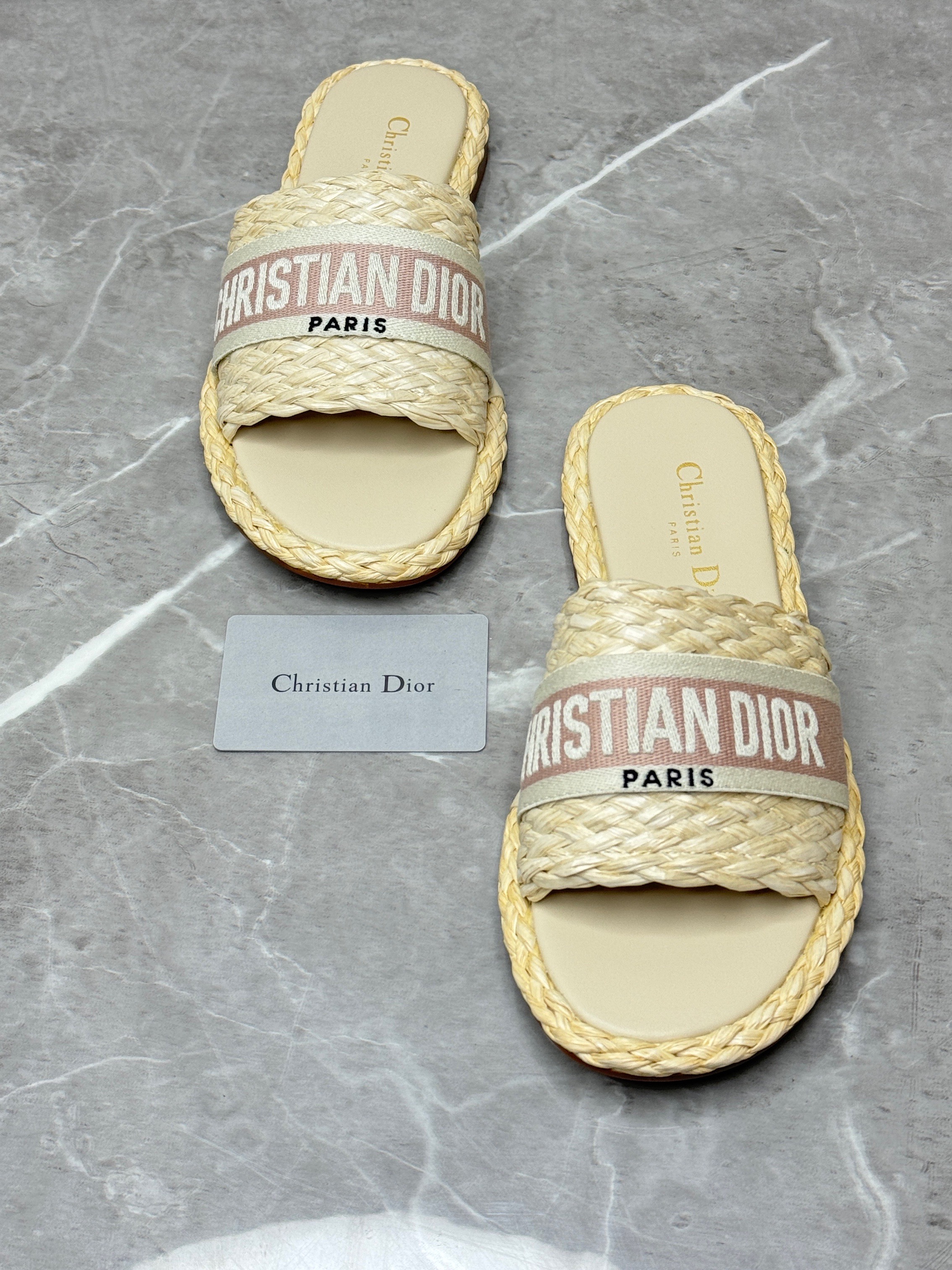 Christian Dior Dway slides in a natural raffia or straw material with a pink embroidered logo. image 1