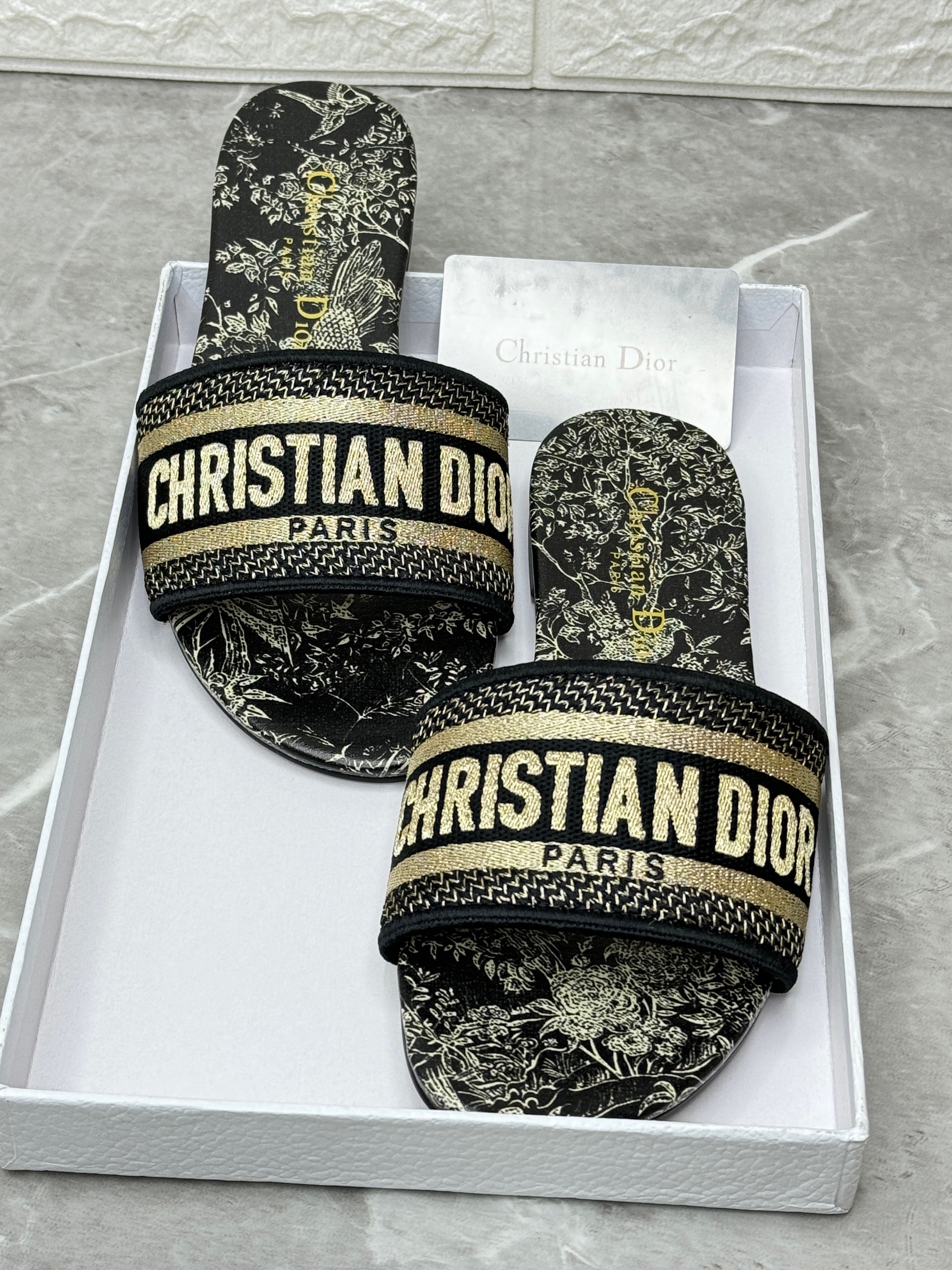 Christian Dior Dway slides with a black and gold-tone embroidered cotton upper featuring the "Christian Dior Paris" signature. image 1