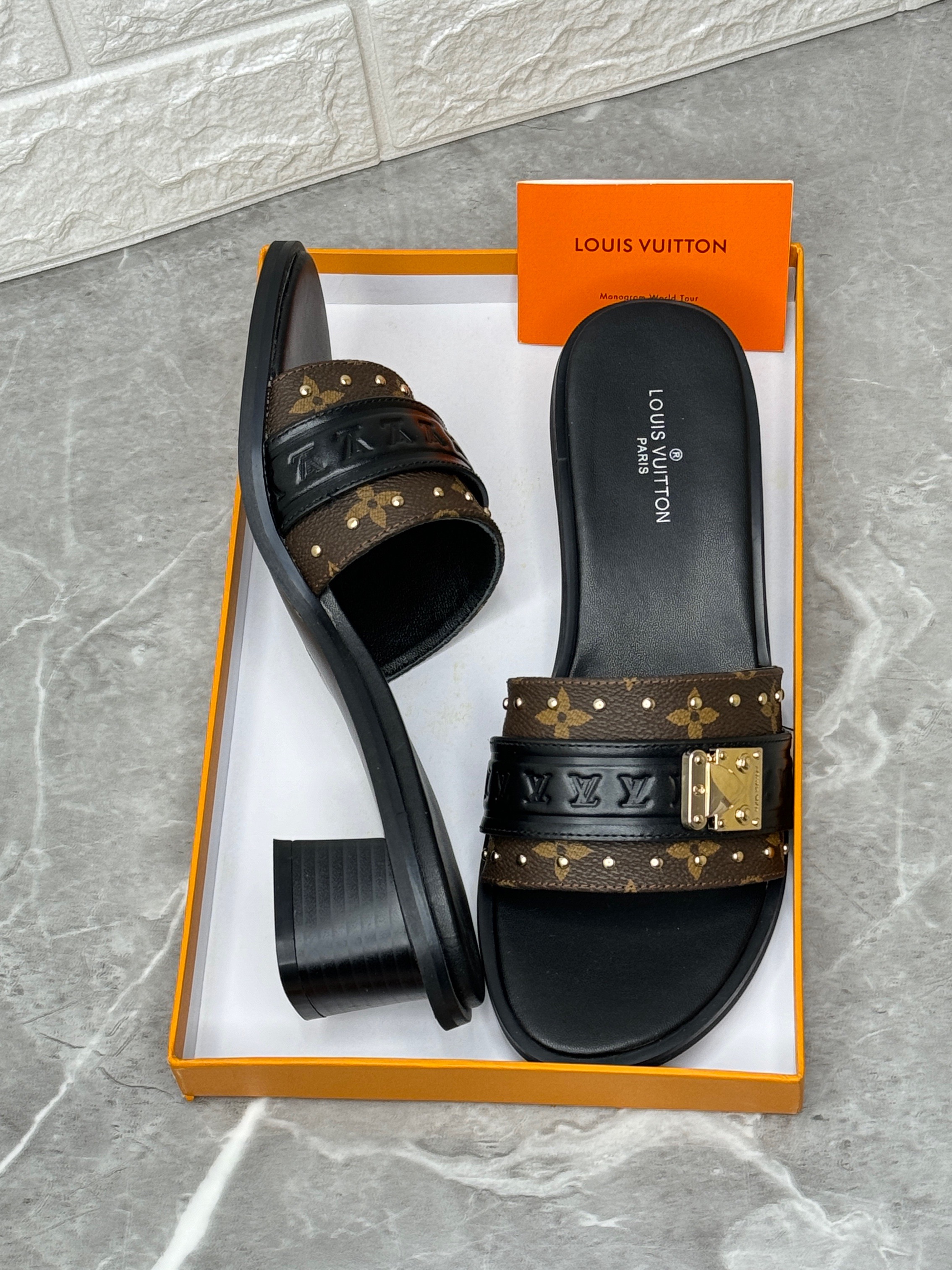 Louis Vuitton Lock It flat slides in black and brown monogram canvas. image 1