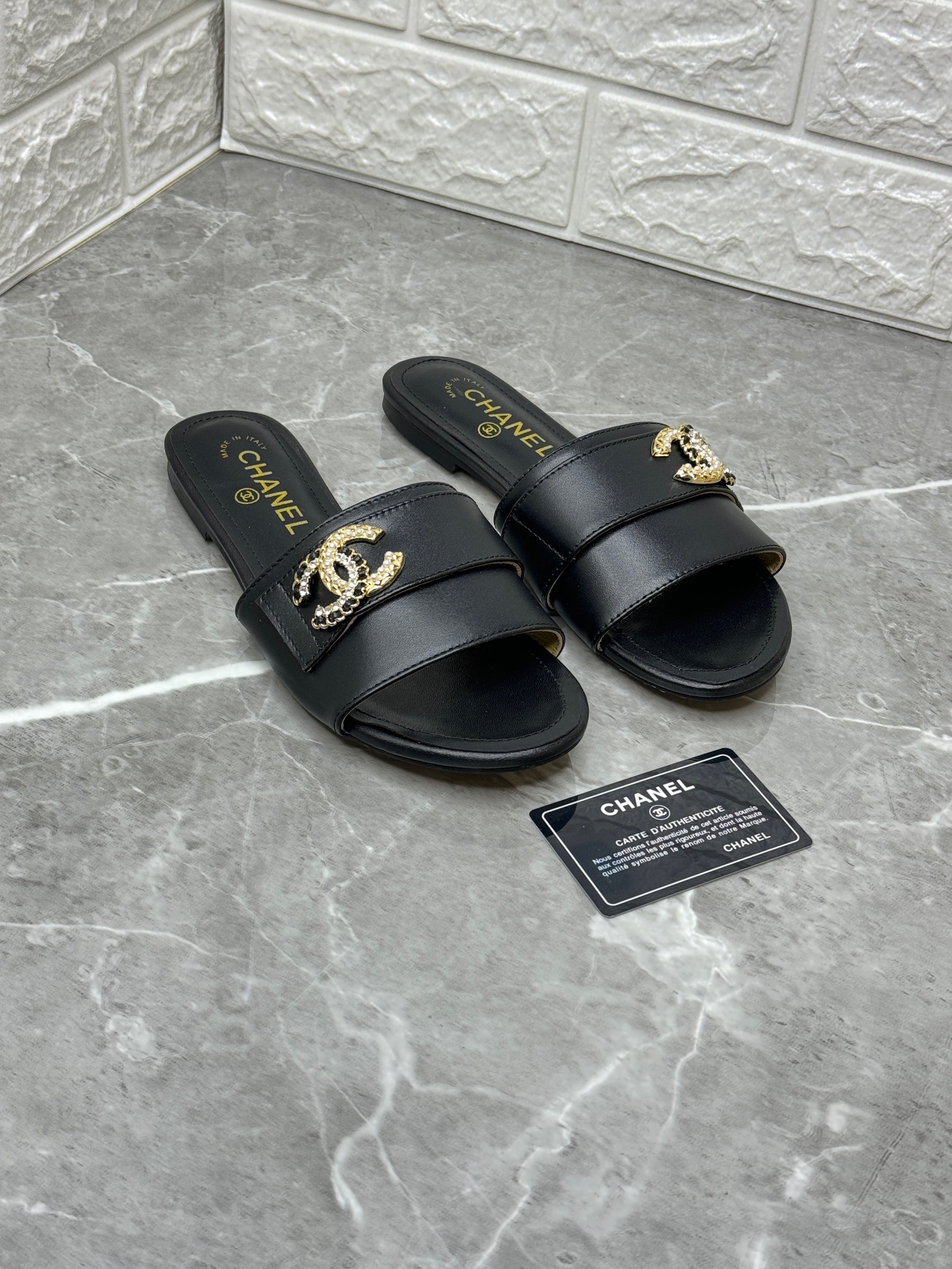Chanel black leather flat slide sandals with crystal-embellished CC motifs. image 1