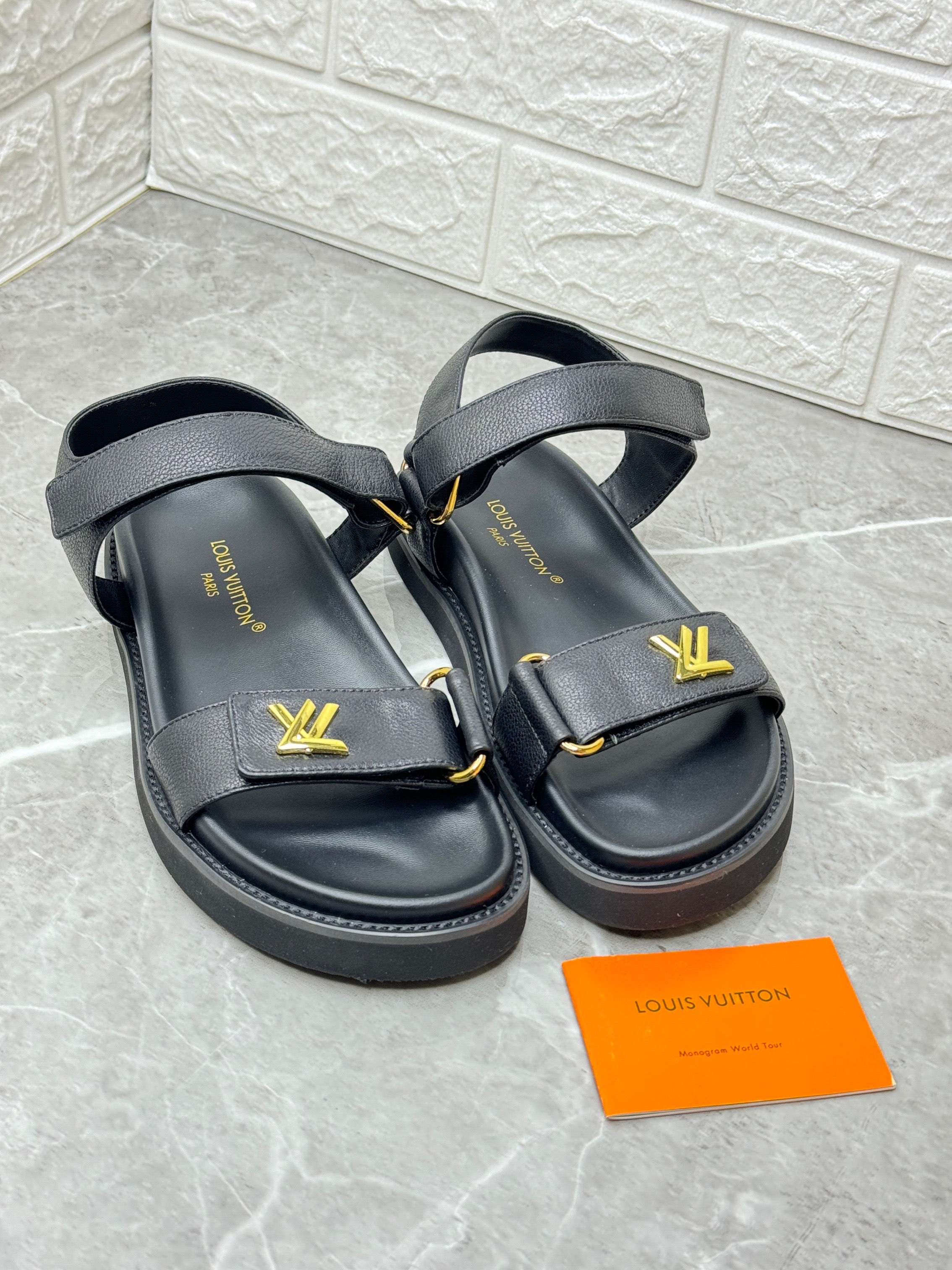 Louis Vuitton Lambskin Sunset Comfort Platform Sandals in black with a gold-tone LV logo. image 1
