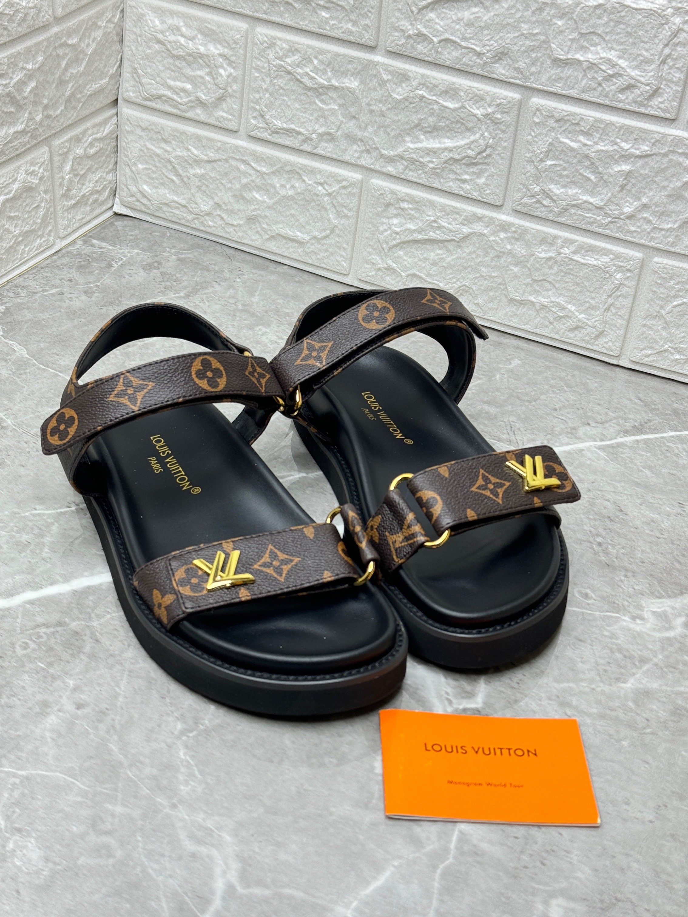 Louis Vuitton LV Sunset Flat Comfort Sandal in the Cacao Brown Patent Monogram canvas. image 1