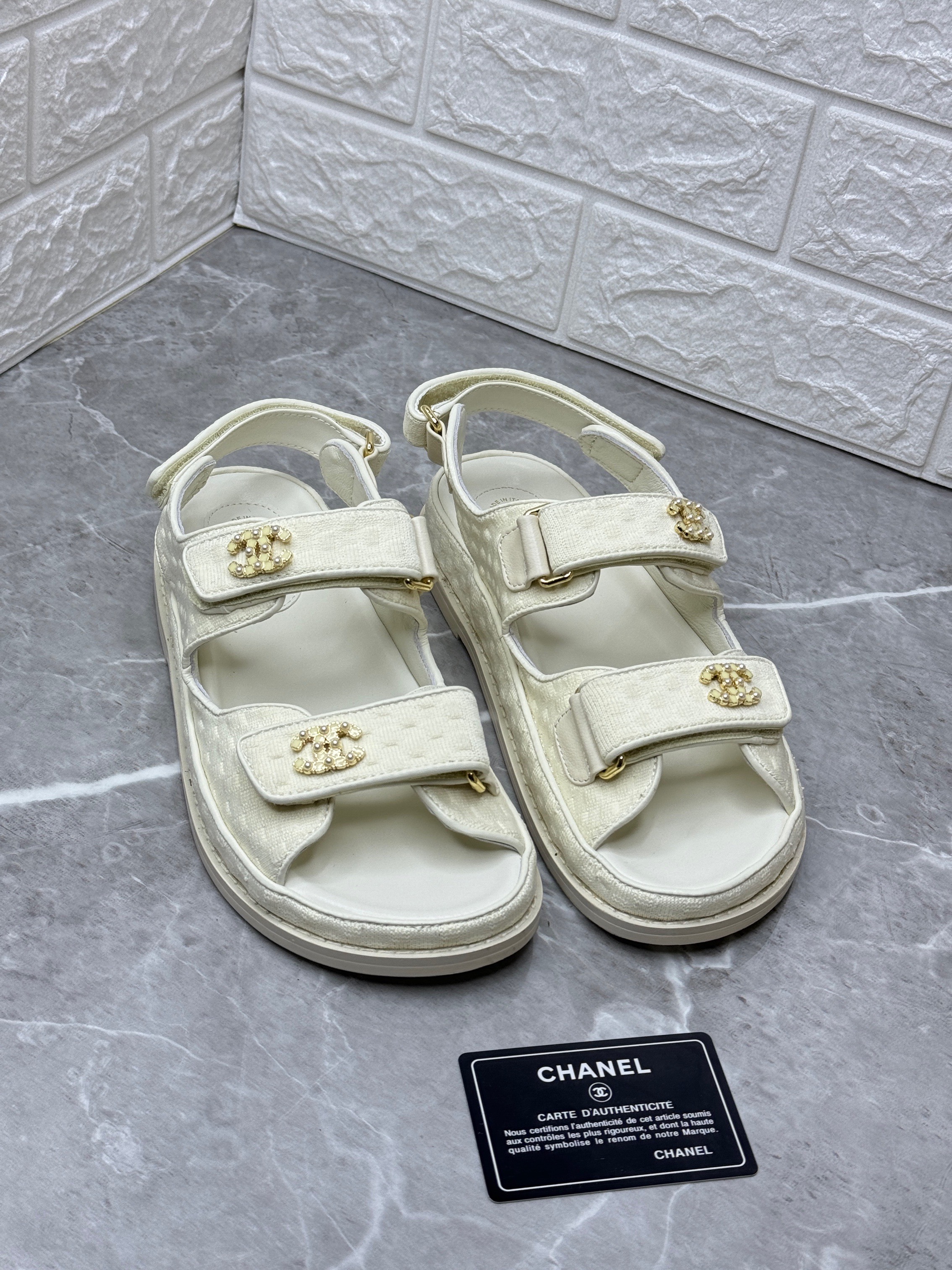 Chanel Dad sandals in white calfskin or lambskin leather with gold-tone hardware and velcro straps. image 1