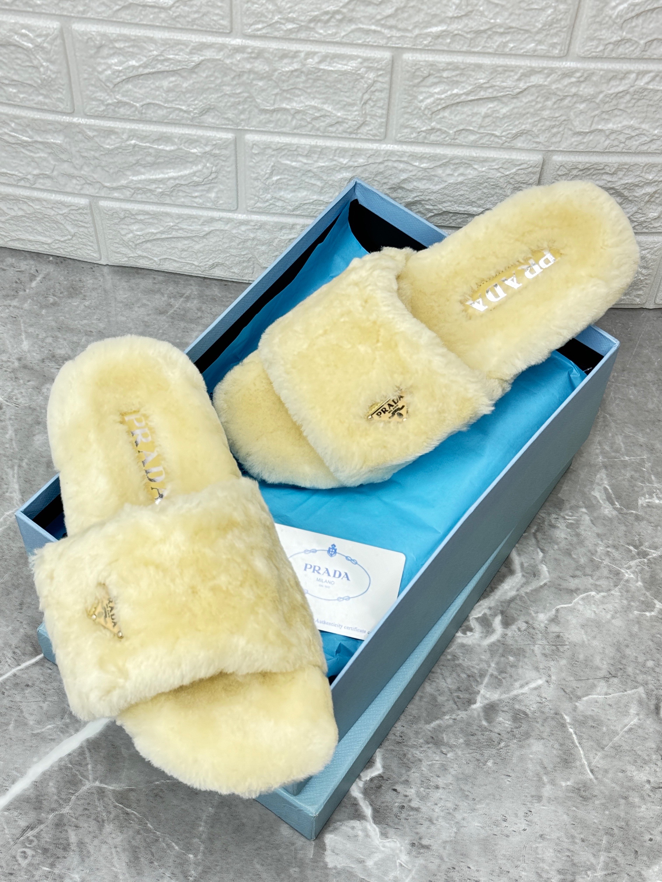 Prada shearling or faux fur slides in white. image 1