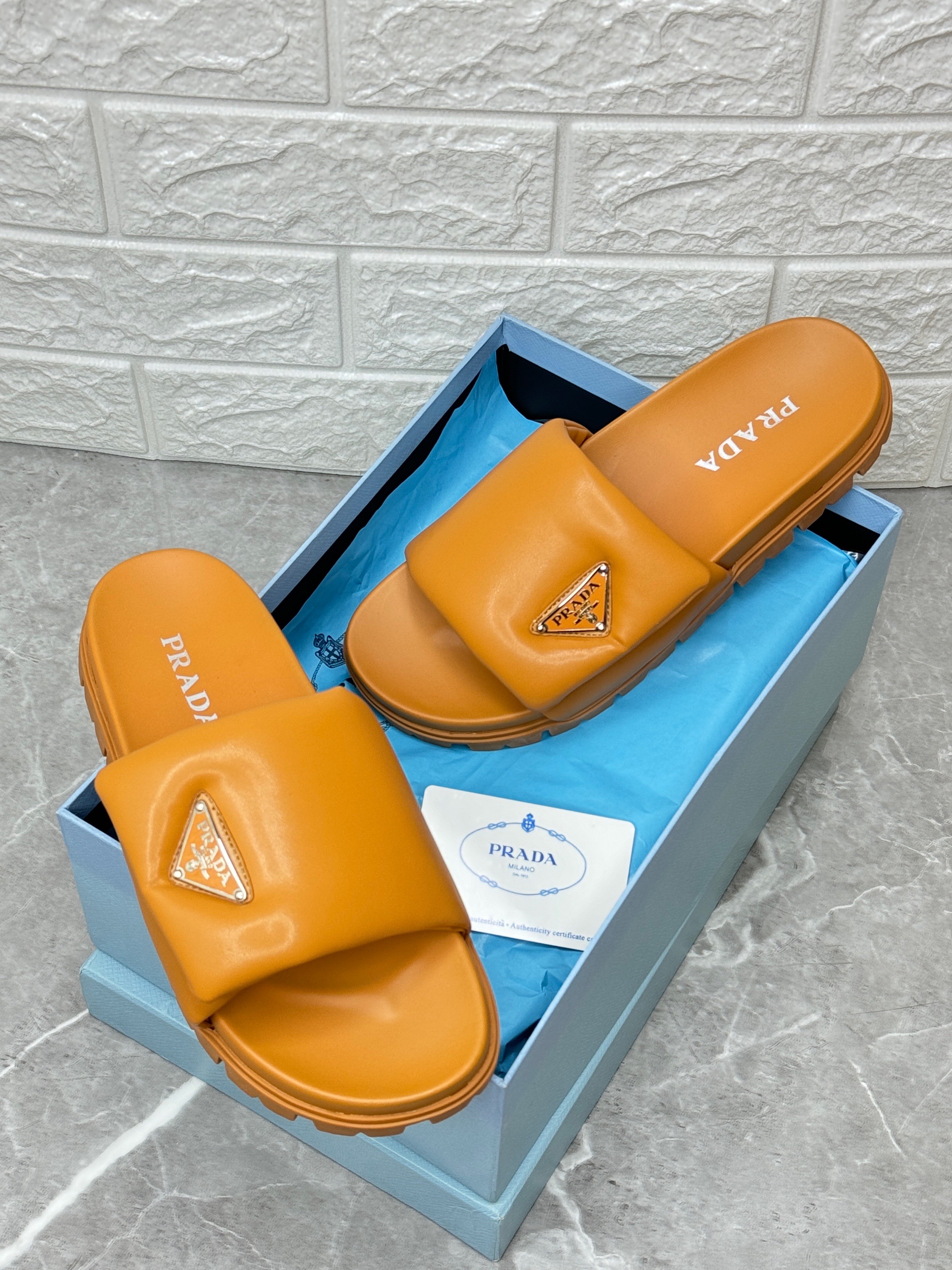 Prada logo rubber slides in the Papaya orange color. image 1