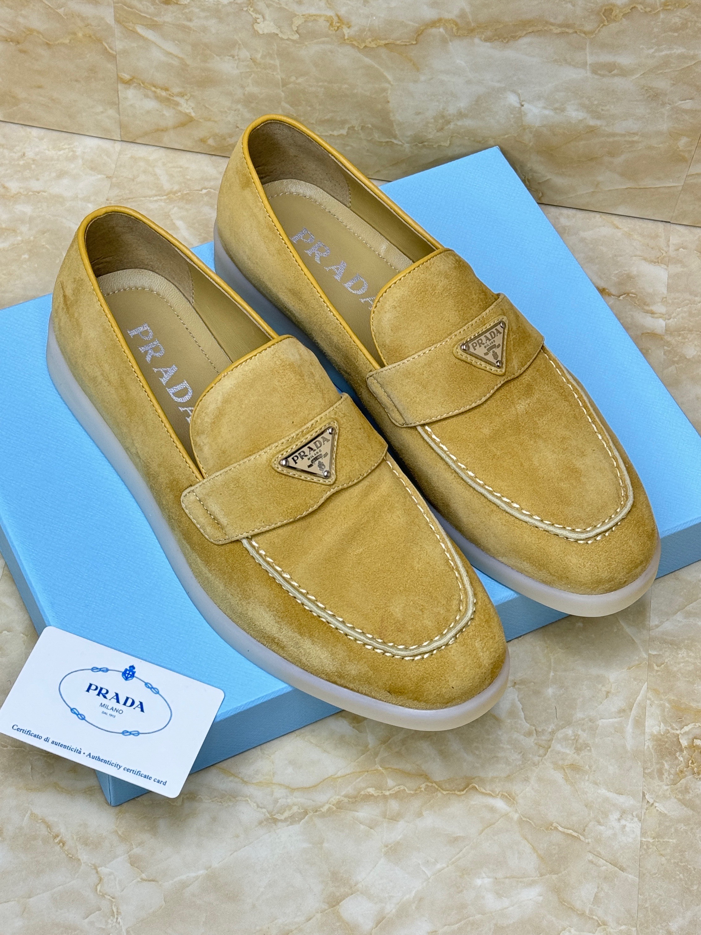 Prada Suede Loafers in a beige/ecru color with the brand's iconic enameled metal triangle logo. image 1