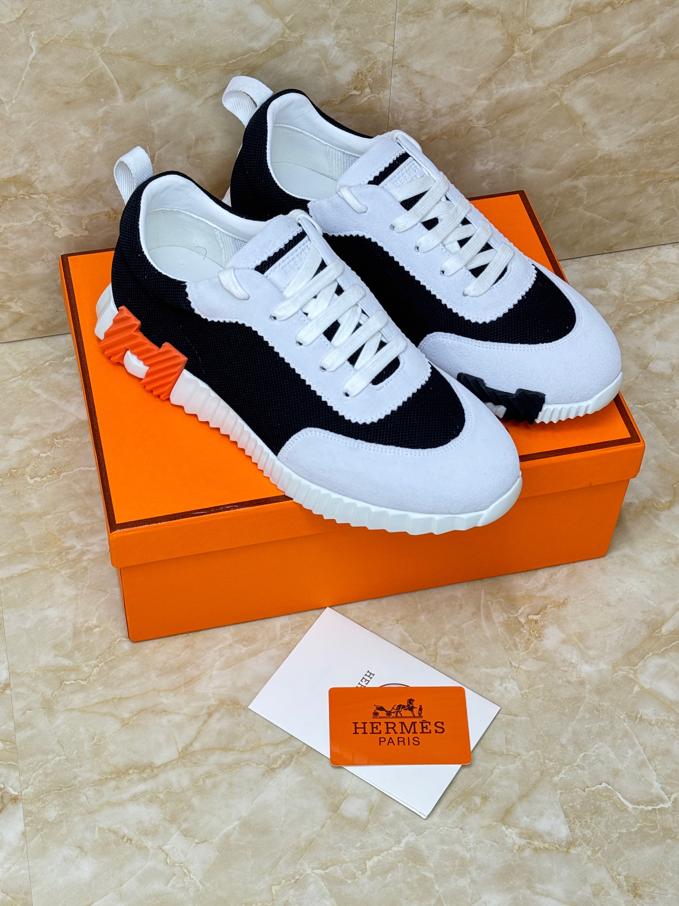 Herm?s Bouncing sneakers in black and white technical mesh and suede goatskin with orange details. image 1