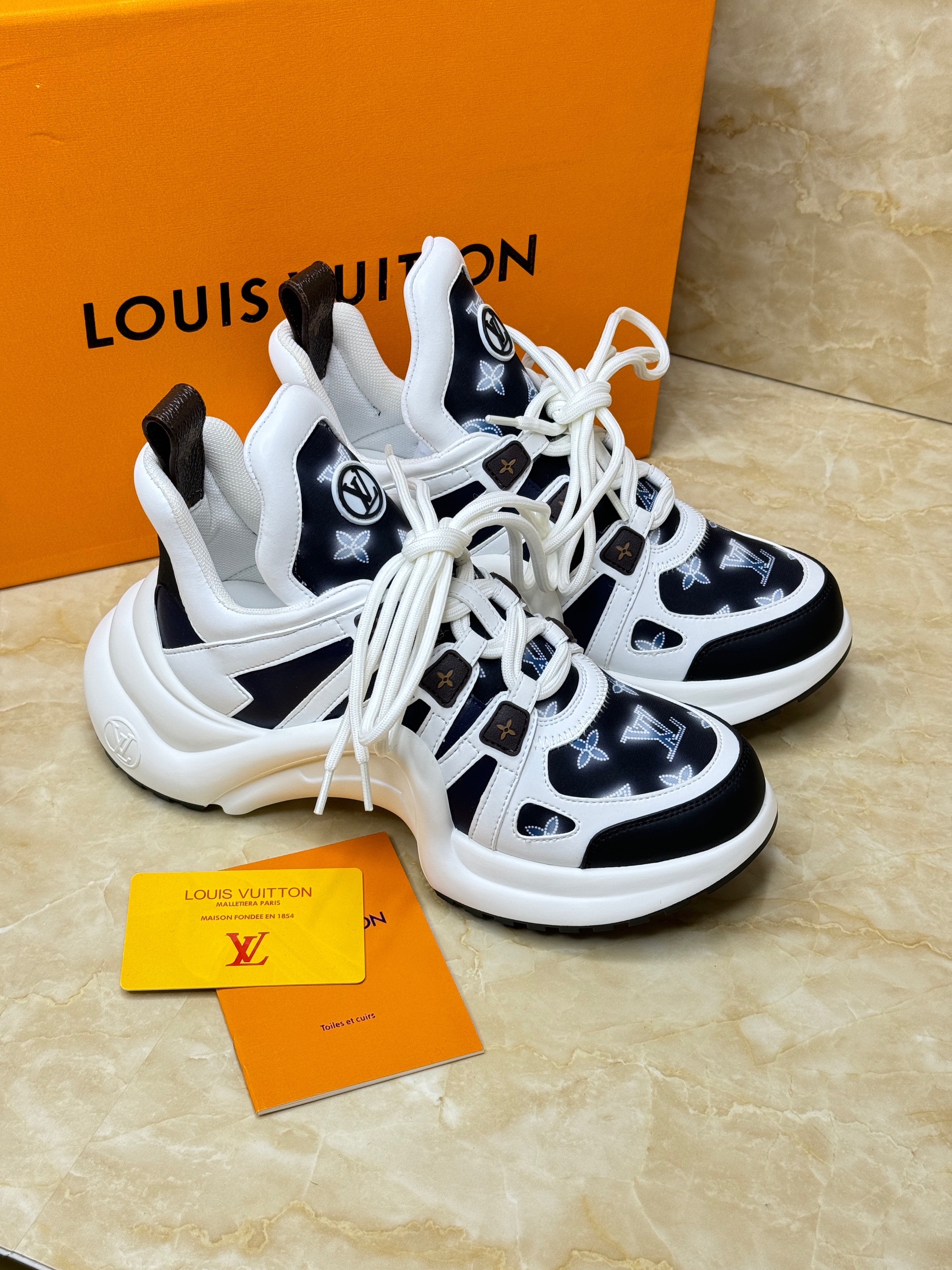 Louis Vuitton LV Archlight sneaker in white and black embossed calfskin leather. image 1