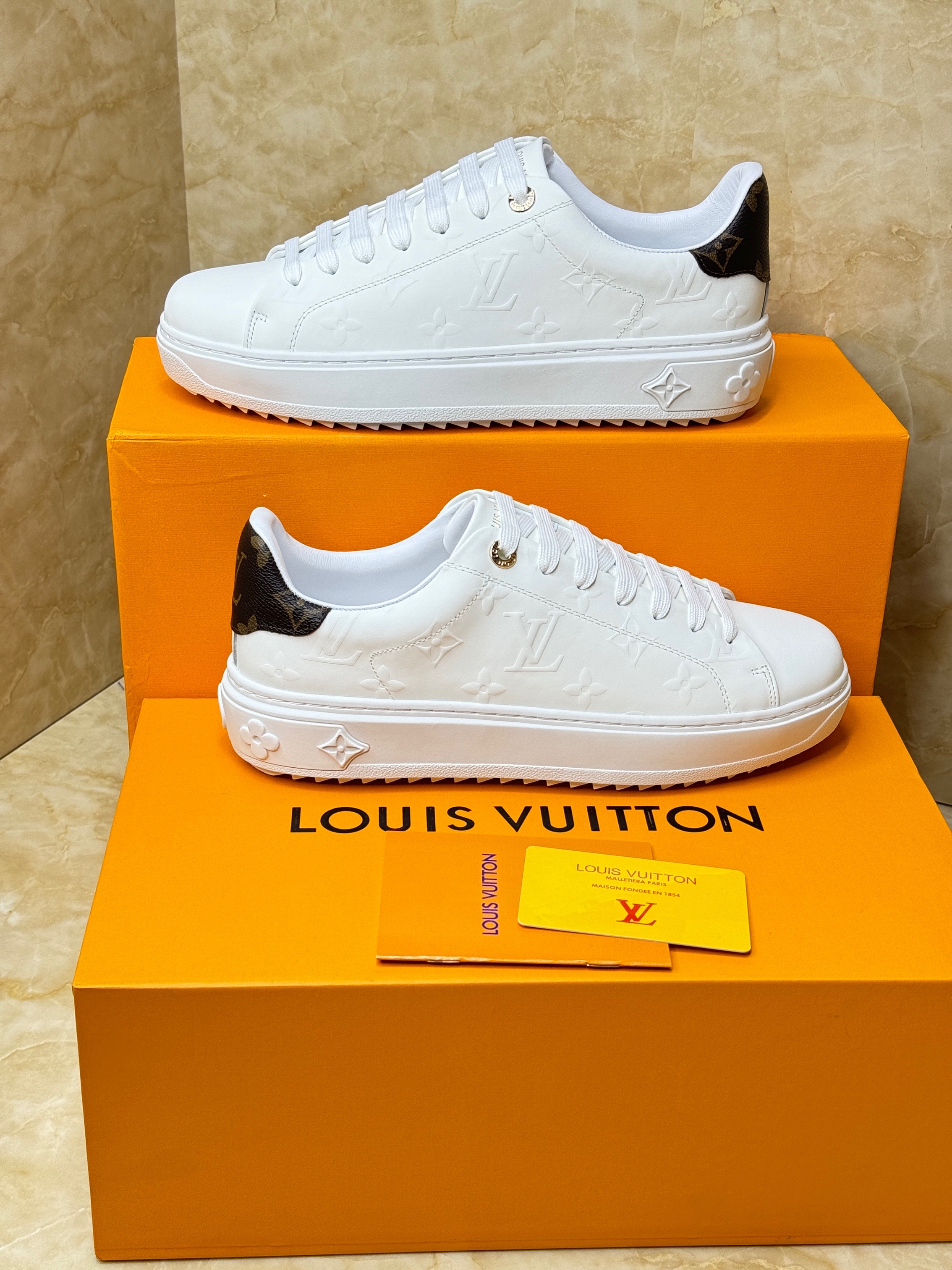 Louis Vuitton Time Out sneaker in white debossed calf leather with a black trim on the back. image 1