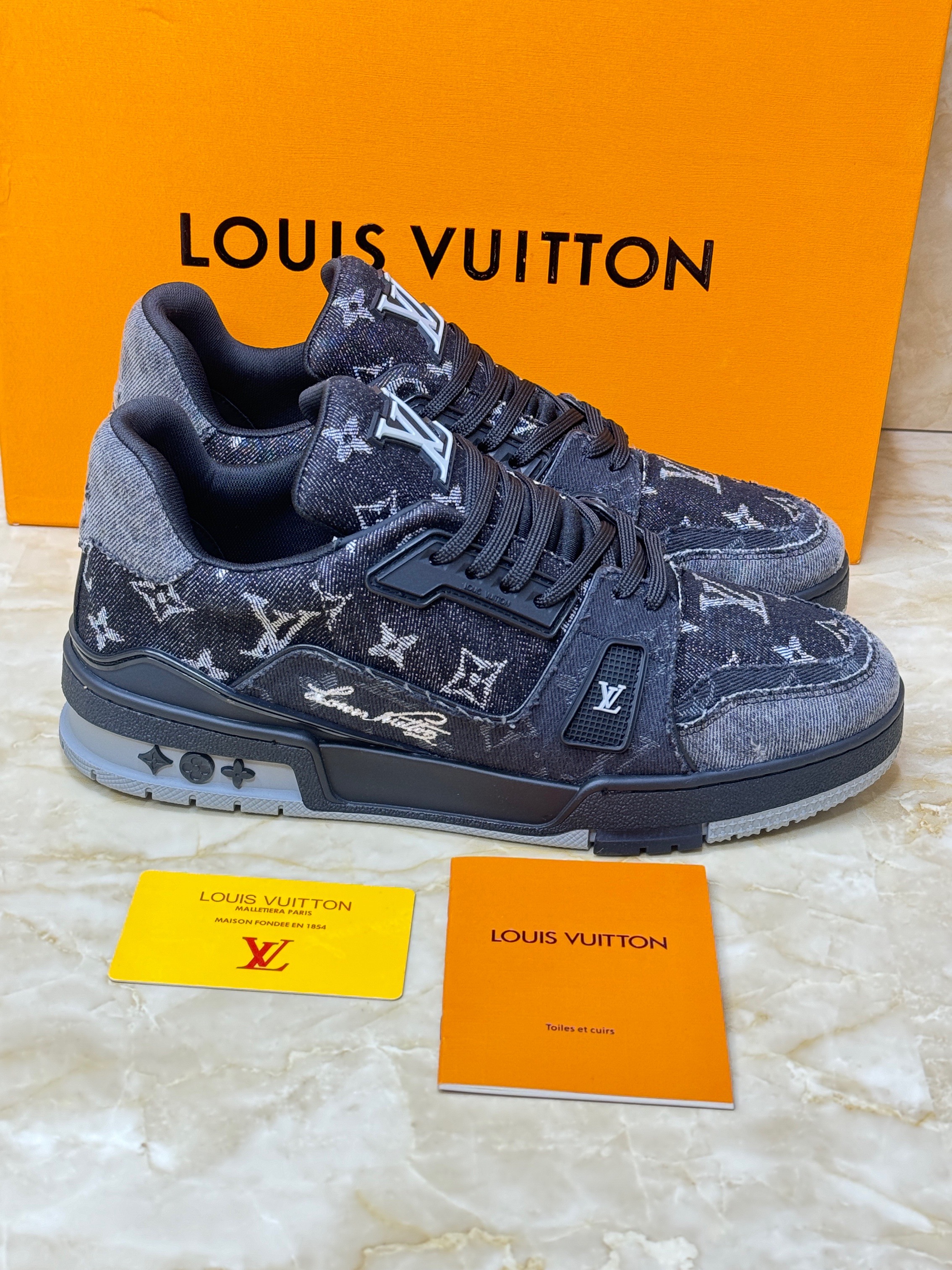 Louis Vuitton LV Trainer sneaker in gray Monogram denim and Monogram-embossed grained calf leather. image 1