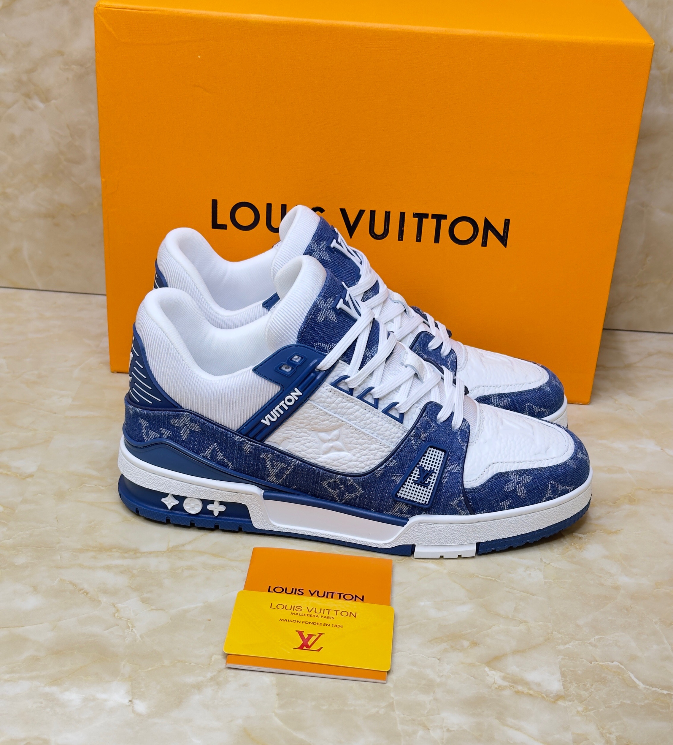 Louis Vuitton LV Trainer Monogram Denim sneaker in white and blue. image 1