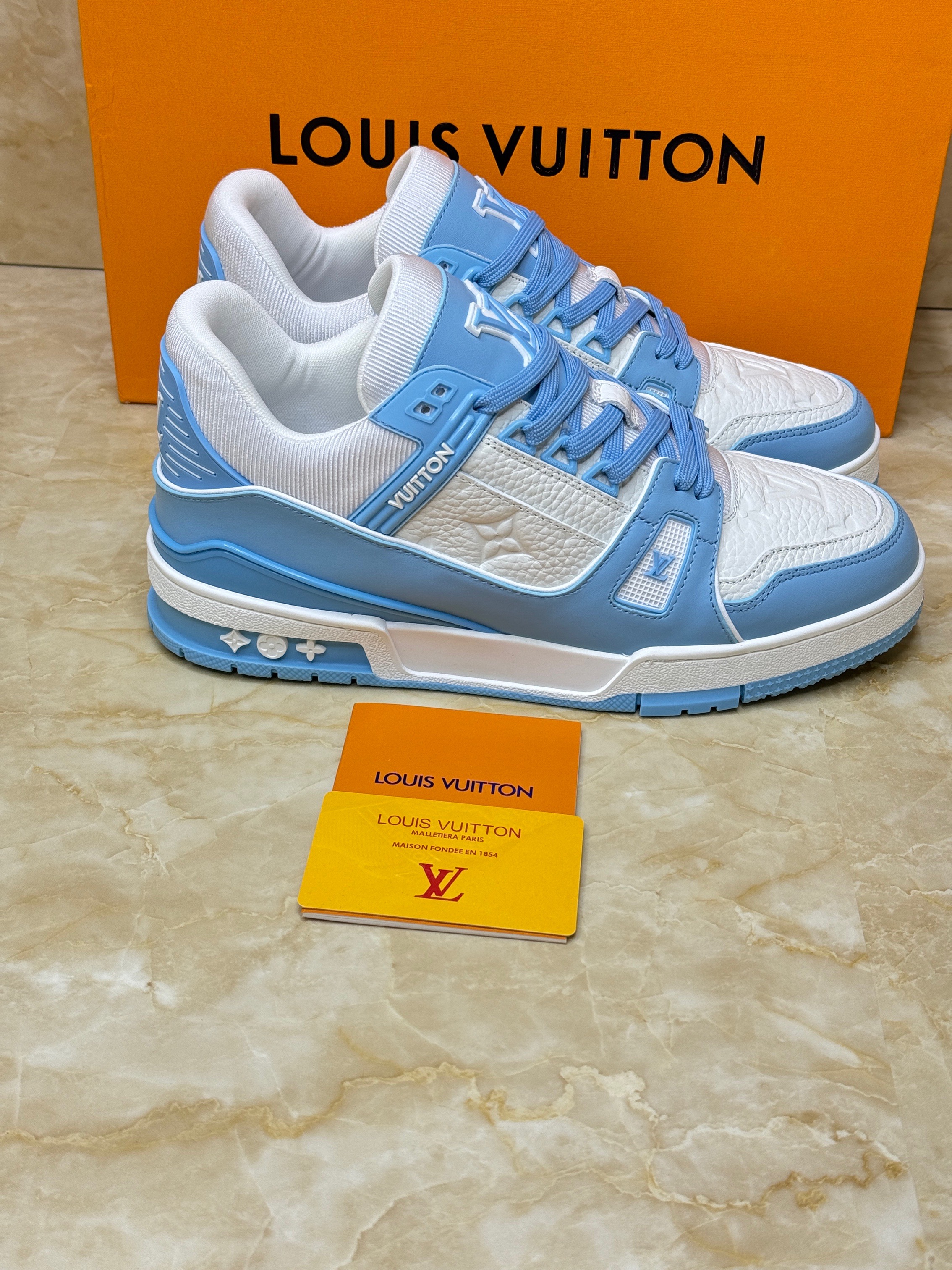 Louis Vuitton LV Trainer sneaker in blue and white monogram denim and monogram-embossed grained calf leather. image 1
