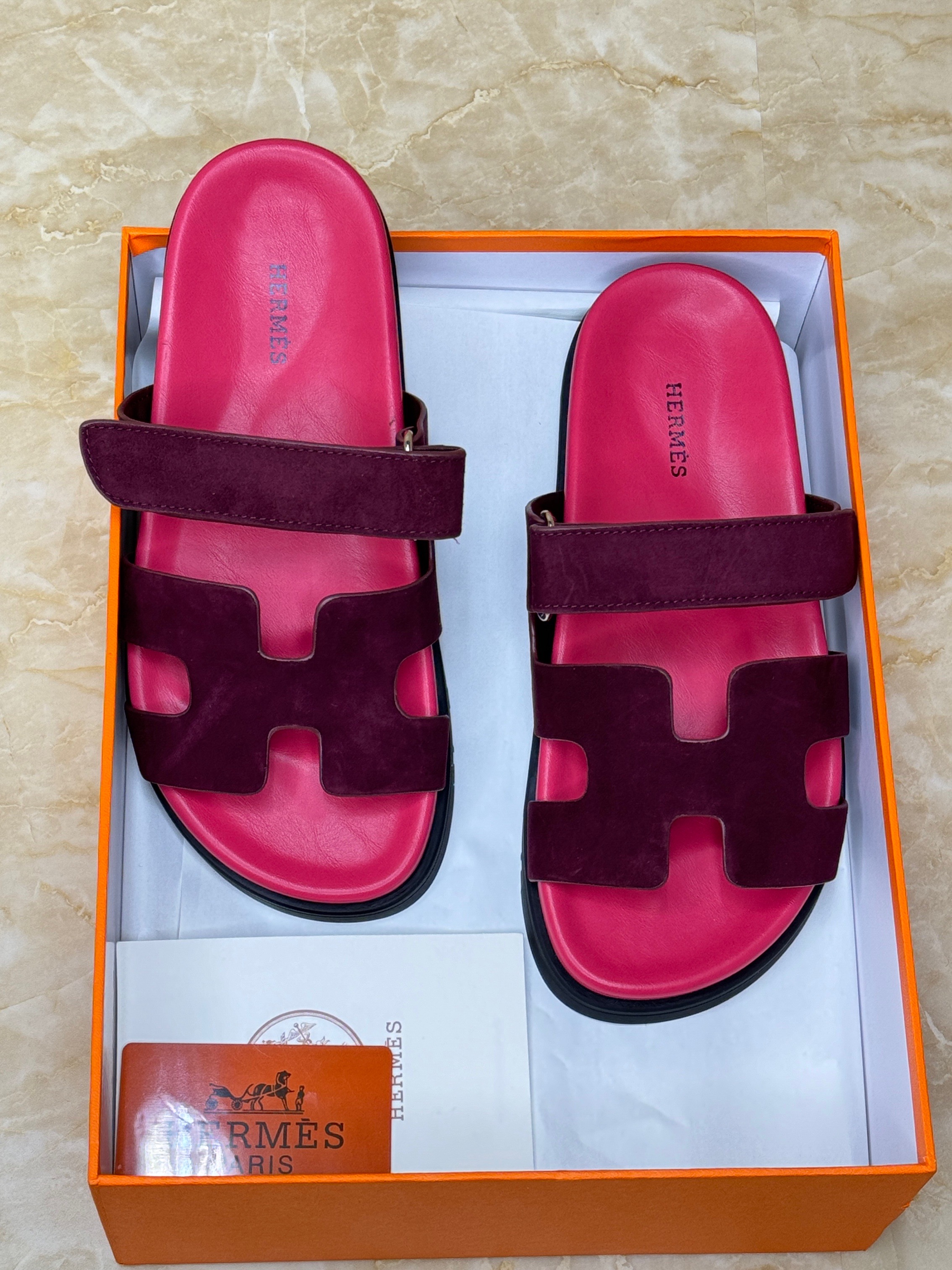Herm?s Chypre sandals with a dark upper strap and a vibrant pink/orange sole. image 1