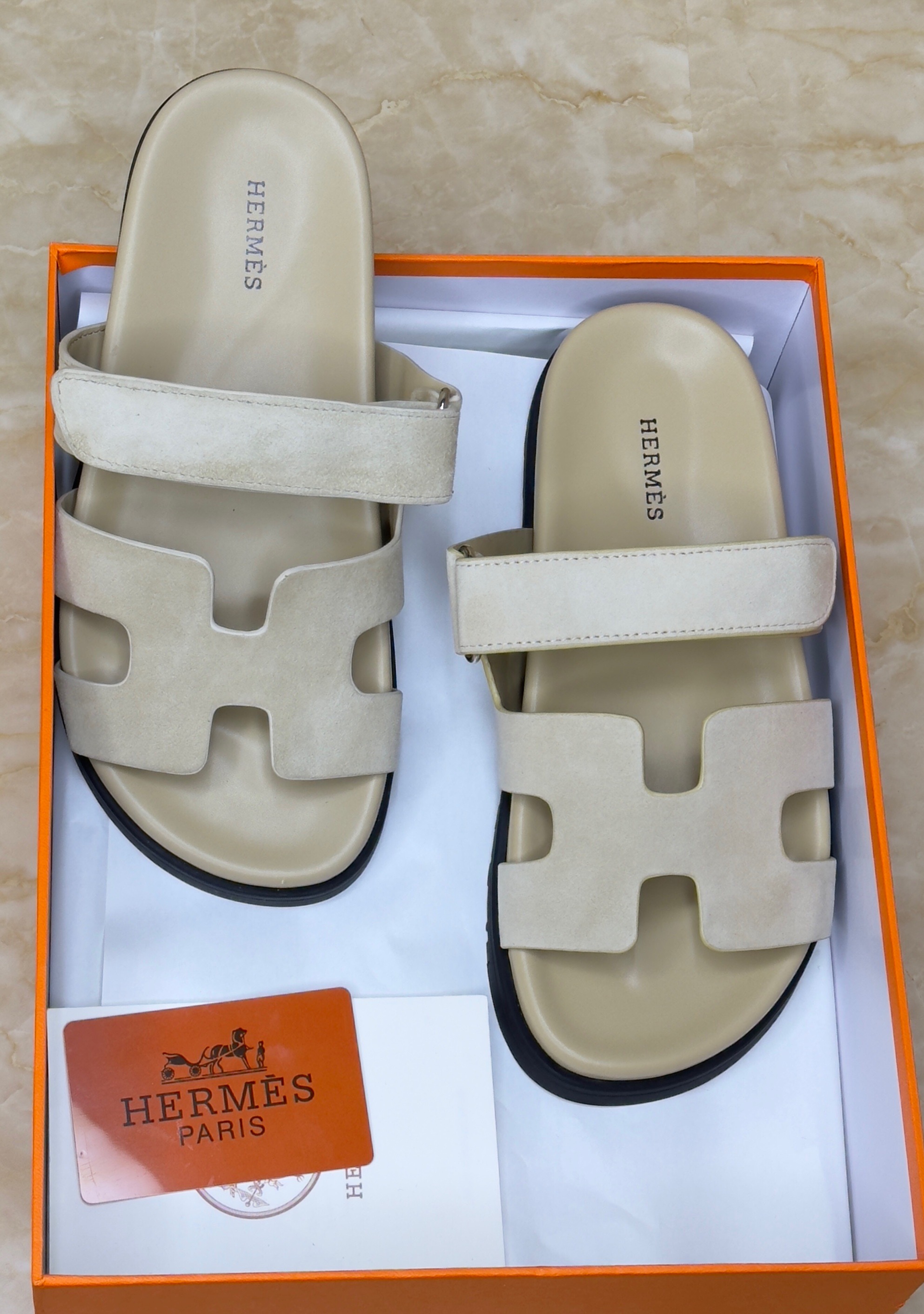 Herm?s Chypre sandals in a light beige or off-white color, featuring an adjustable strap and anatomical rubber sole. image 1