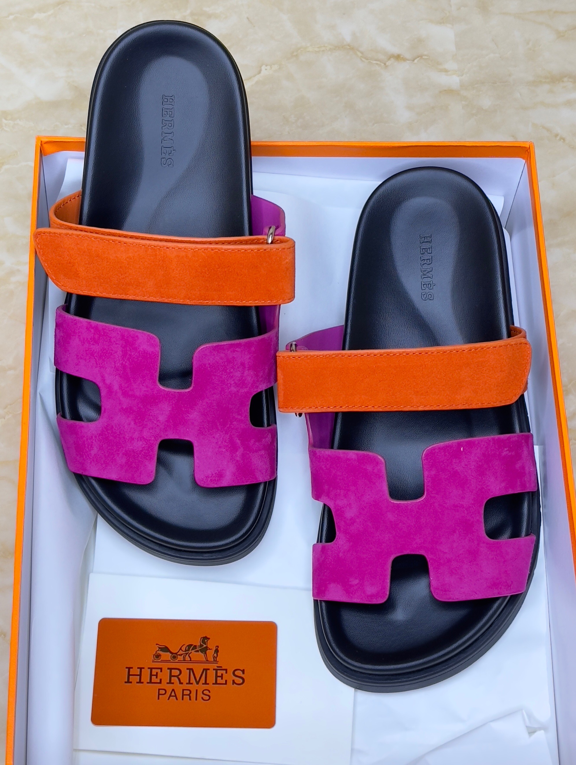 Herm?s Chypre sandals in the Rose Chapas/Orange colorway, crafted from suede goatskin with an anatomical rubber sole and adjustable strap. image 1