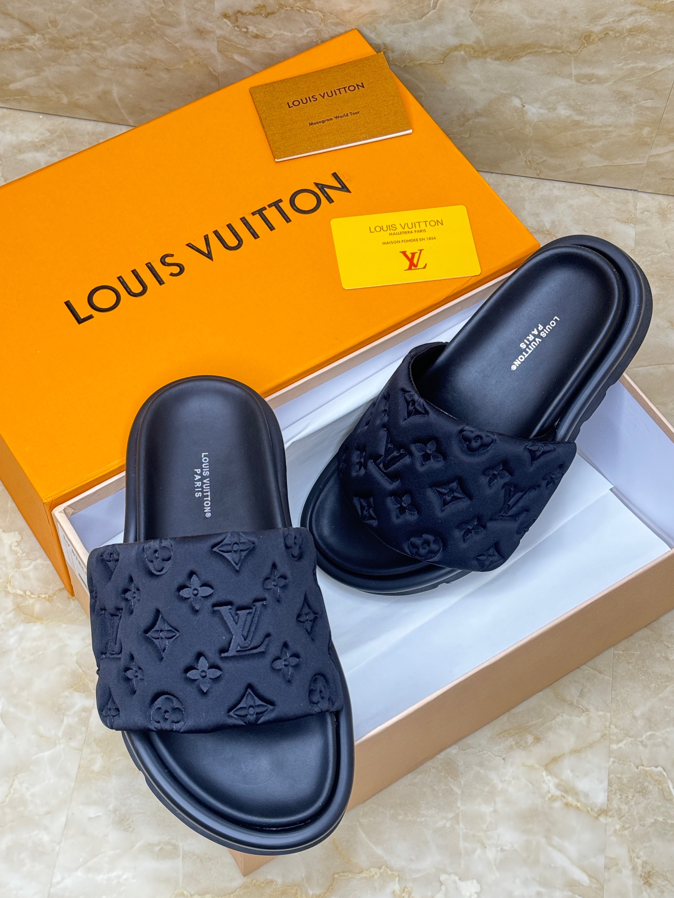 Louis Vuitton Miami mules in black Monogram-embossed synthetic leather. image 1