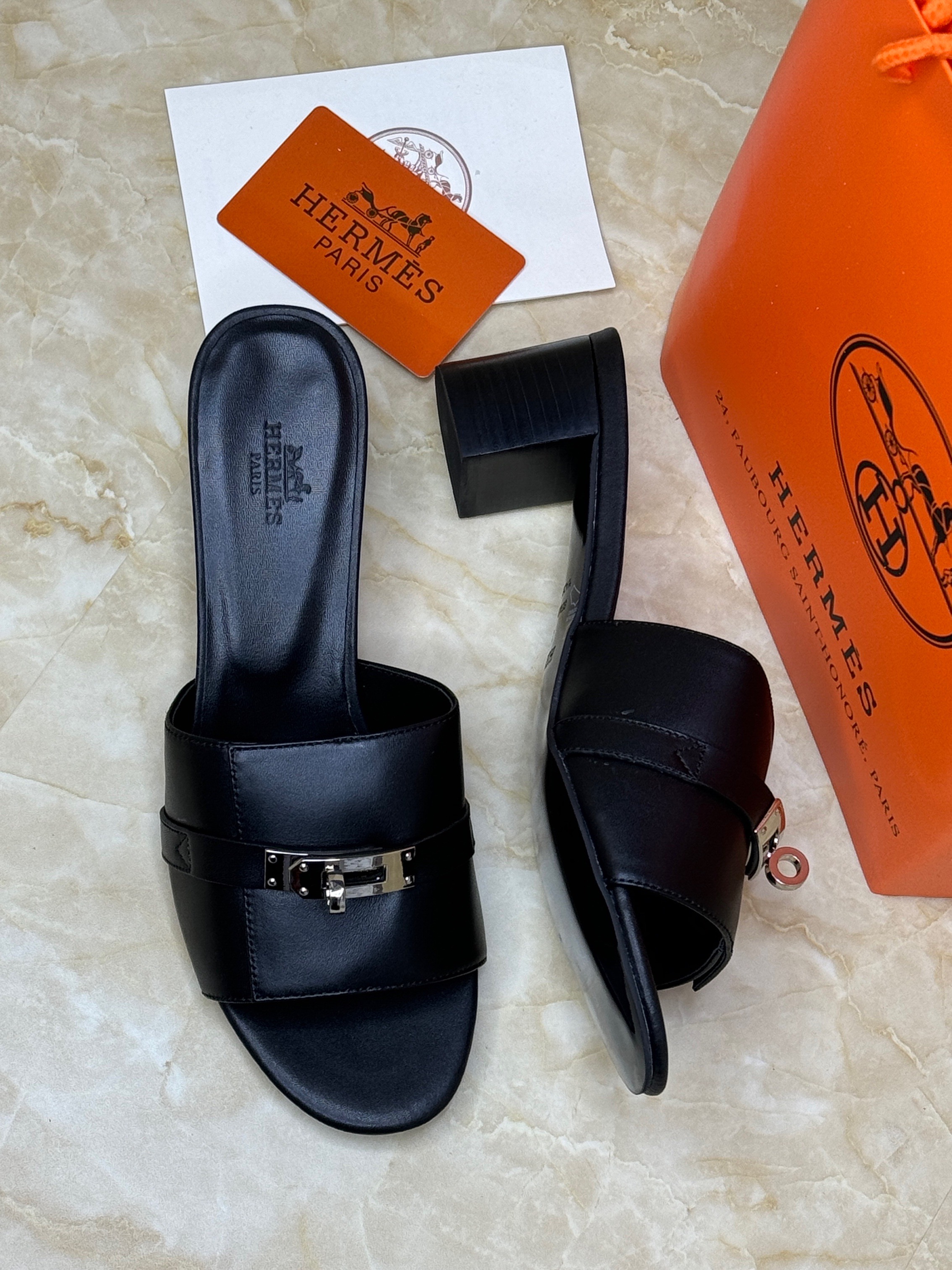 Herm?s Gigi 50 sandals in black suede and calfskin with a silver-tone Kelly buckle. image 1
