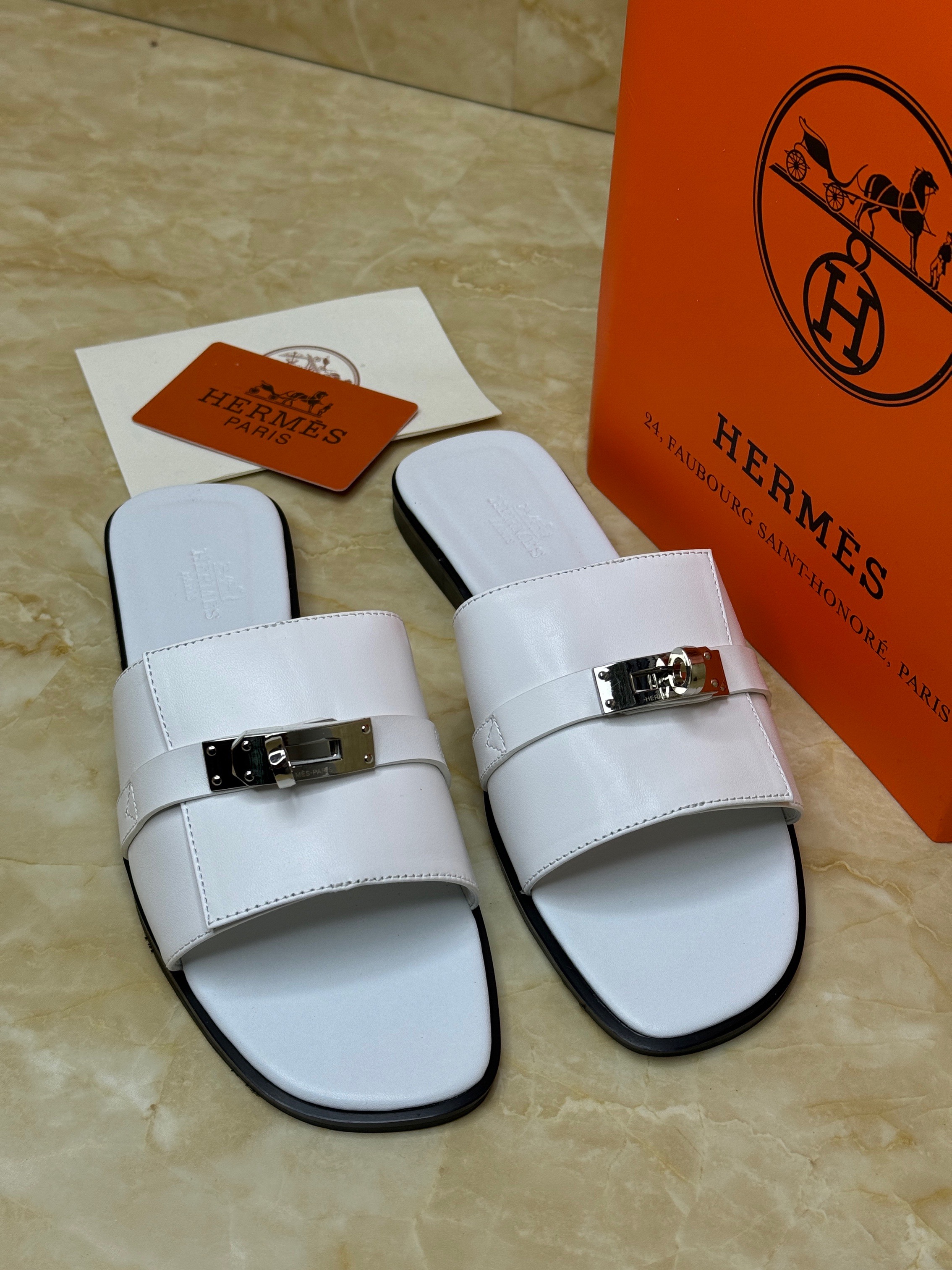 Herm?s Oz mules in white calfskin leather with a silver Kelly buckle. image 1