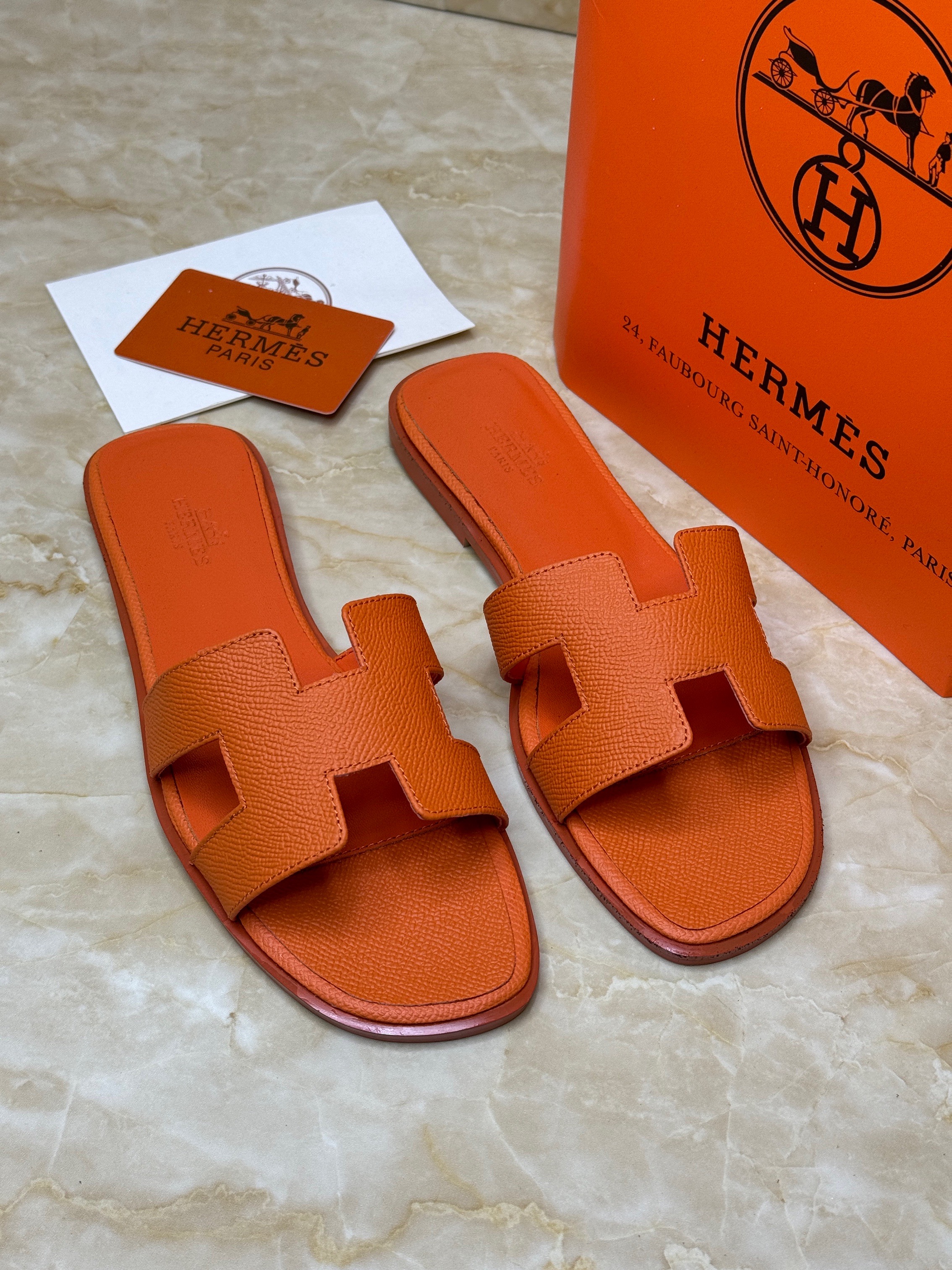 Herm?s Oran sandals in orange leather. image 1