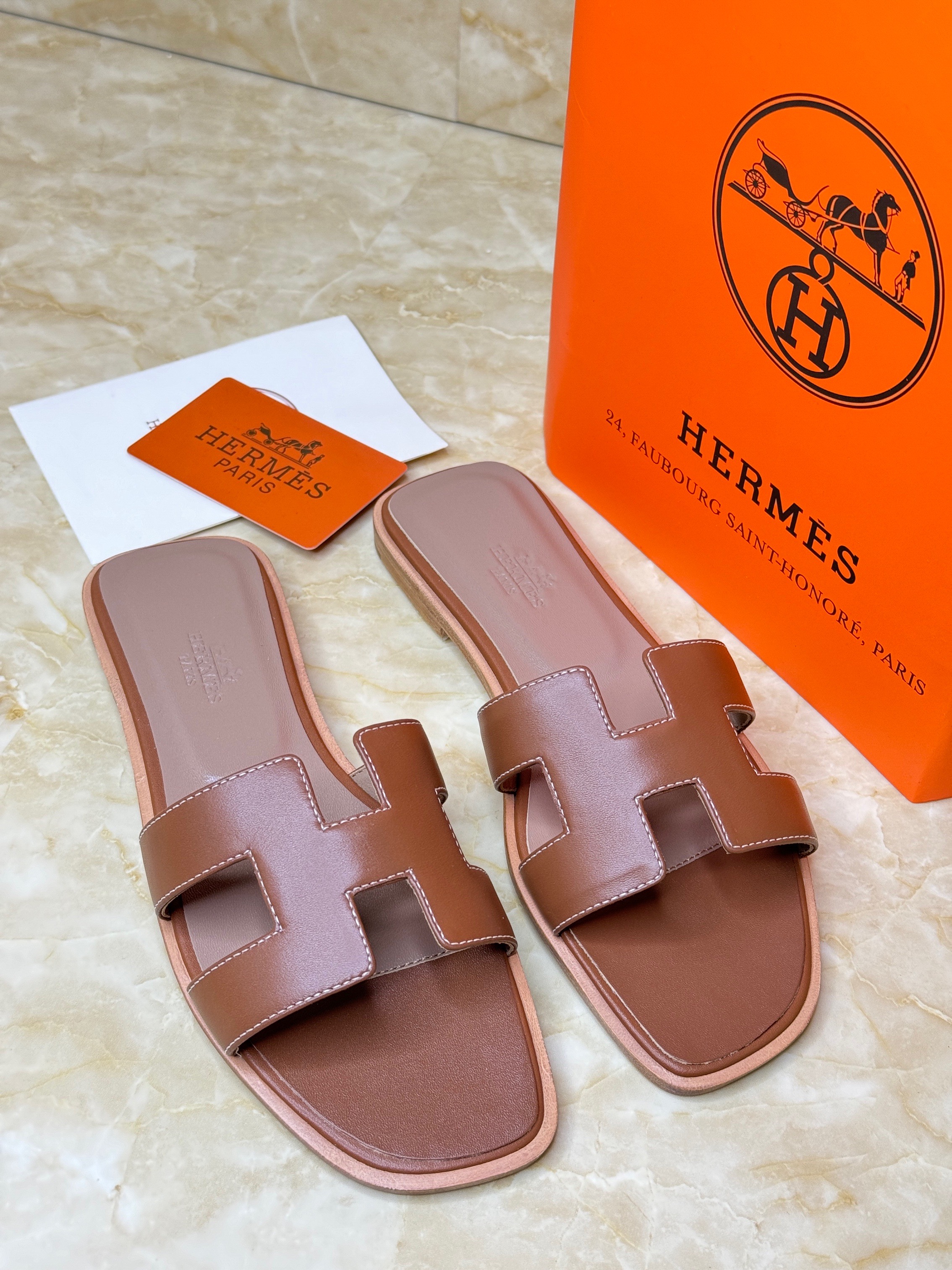 Herm?s Oran sandals in brown calfskin leather with the iconic "H" cut-out strap design. image 1