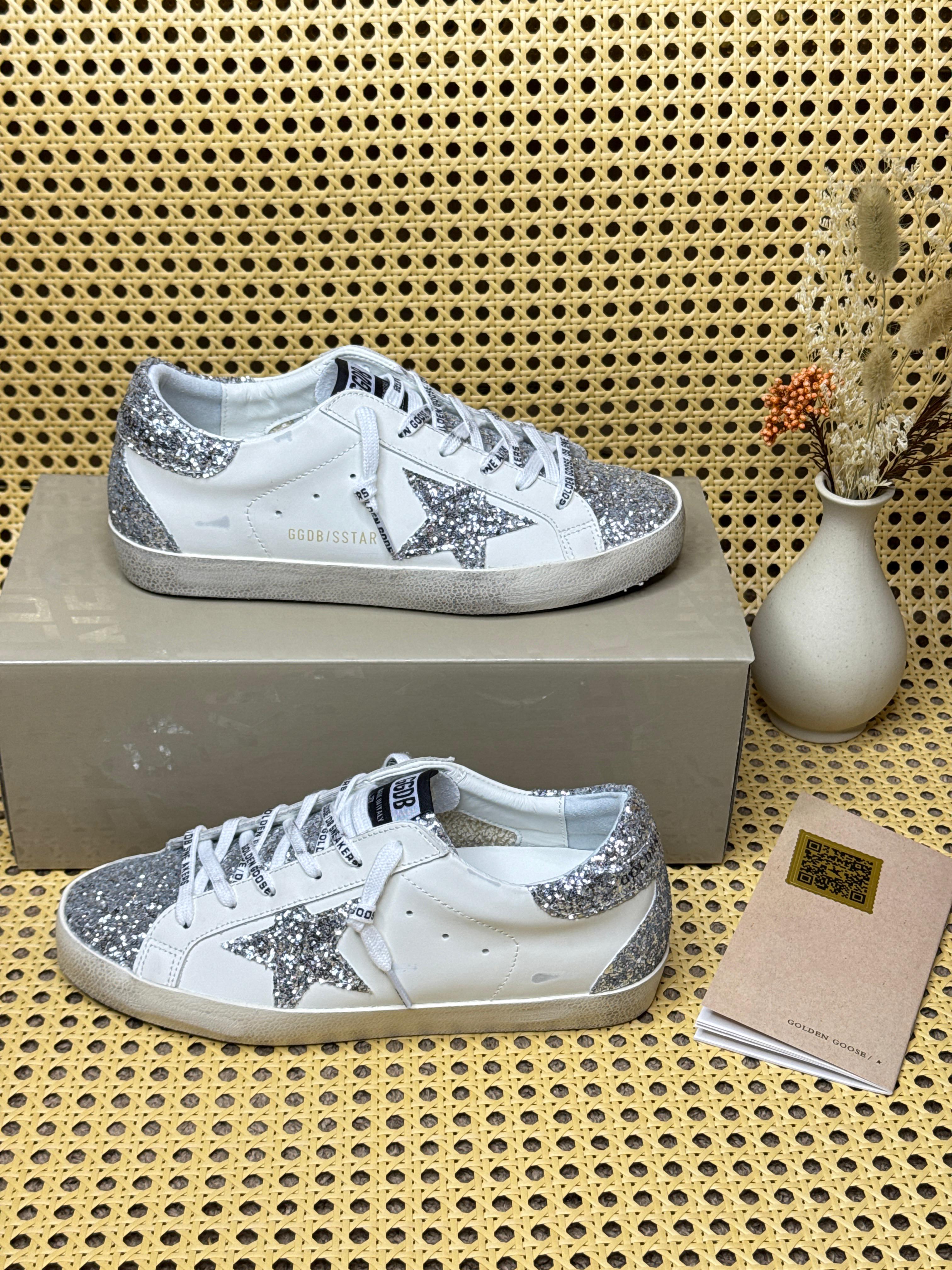Golden Goose Super-Star sneakers featuring glitter panels and a suede star patch image 1