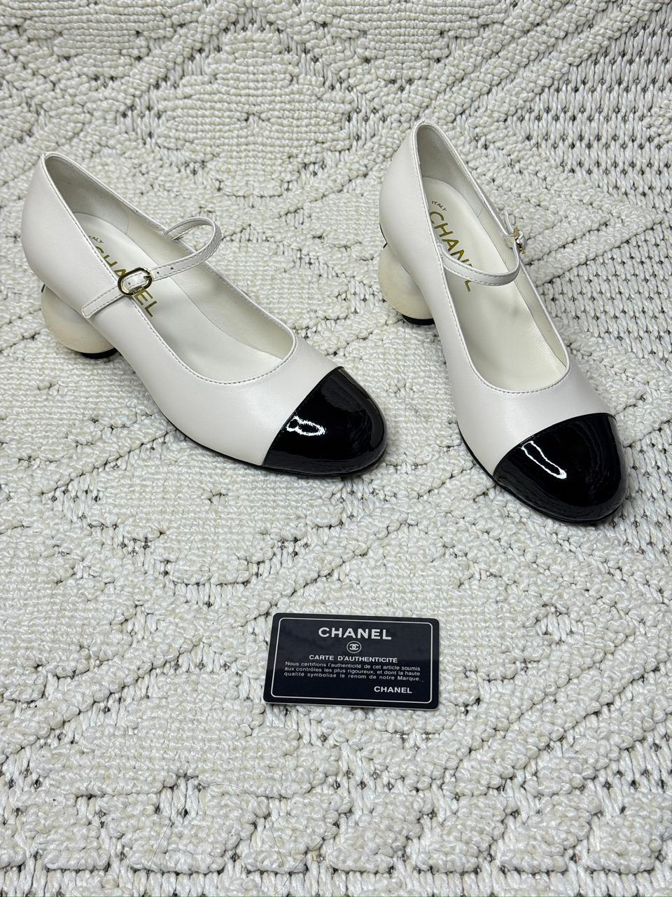 Chanel Mary Jane pumps in white lambskin leather with a black cap toe and a distinctive spherical heel. image 1
